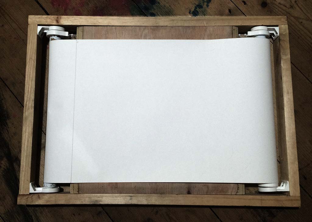 Whilst spending a lot of time sketching at events with a standard sketchbook and pen Martin Squires was also working on larger studio pieces. When working in two different disciplines, one influenced the other so much so that Martin started to think of ways to sketch on larger surfaces whilst sketching on his travels. The solution was this, the Scrolling Sketchpad, capable of holding long rolls of paper this enables production of on site sketches within a tapestry style format.
