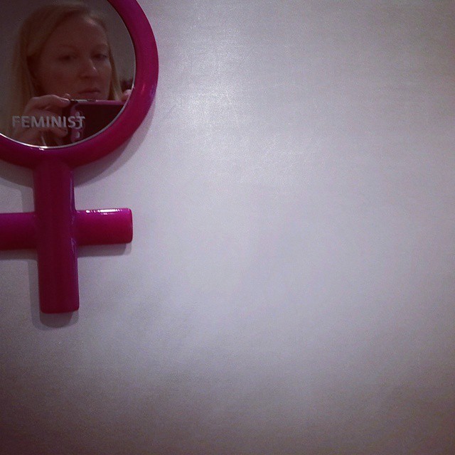 Self-portrait with art by Michele Pred, 2015