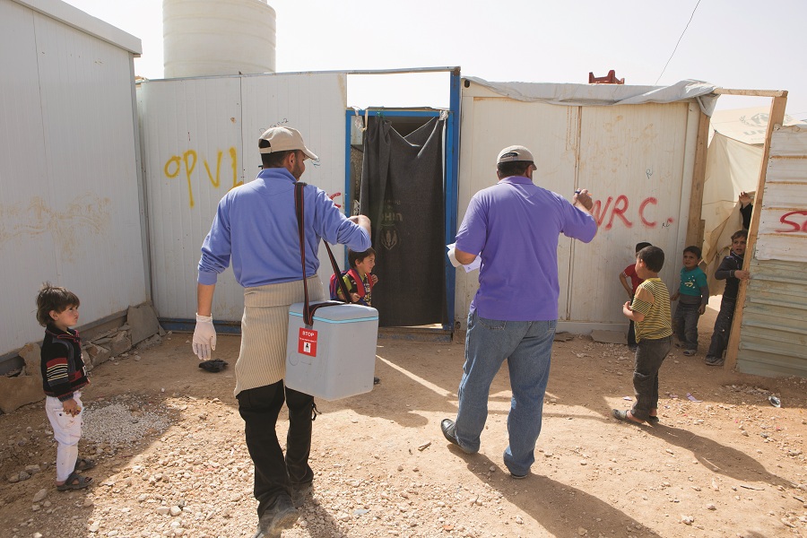 At the Zaatari camp, vaccinators visit every makeshift home in pairs. One volunteer handles the vaccinations, and the other serves as the recordkeeper. 