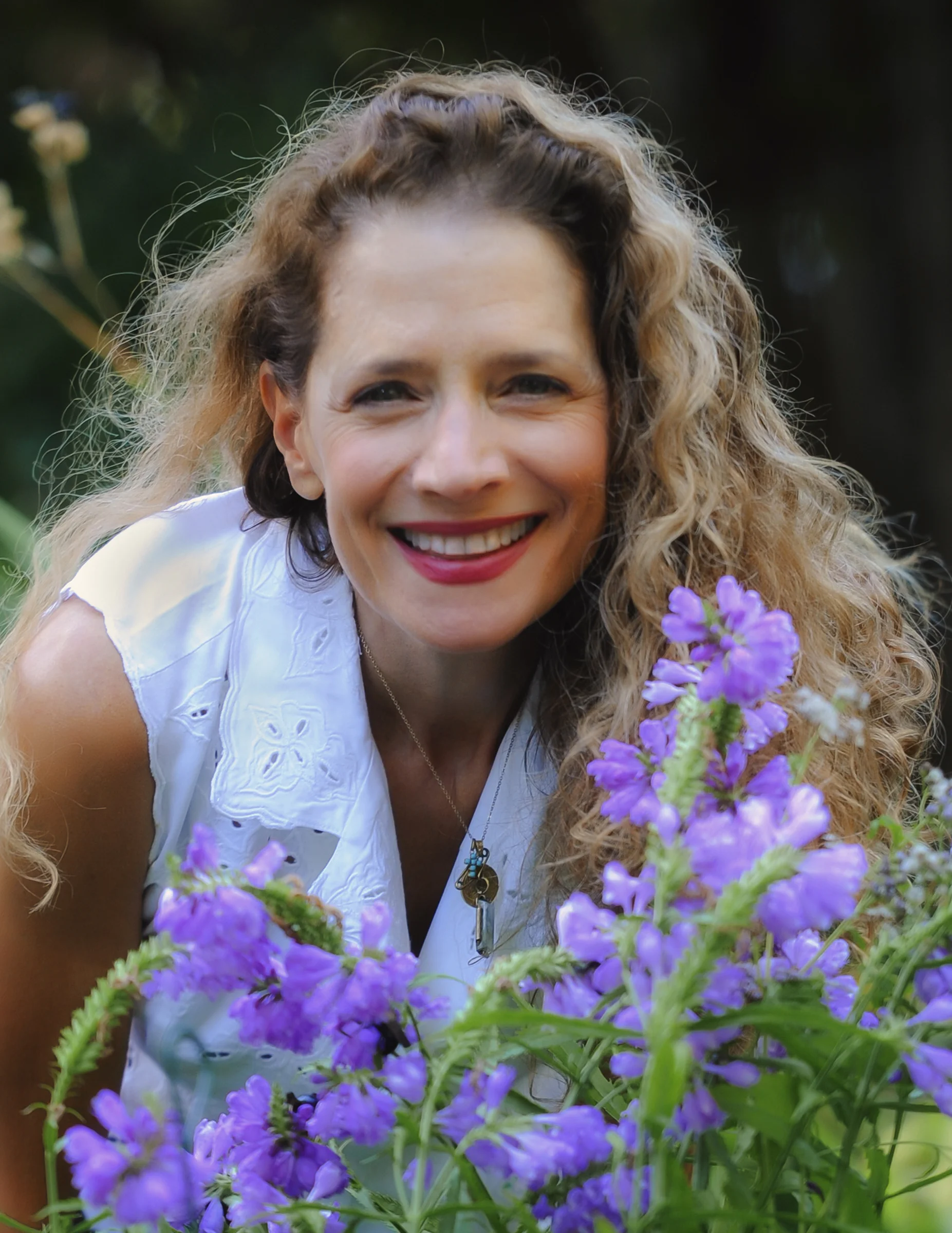 Konstantina Zaras in the garden with purple flowers