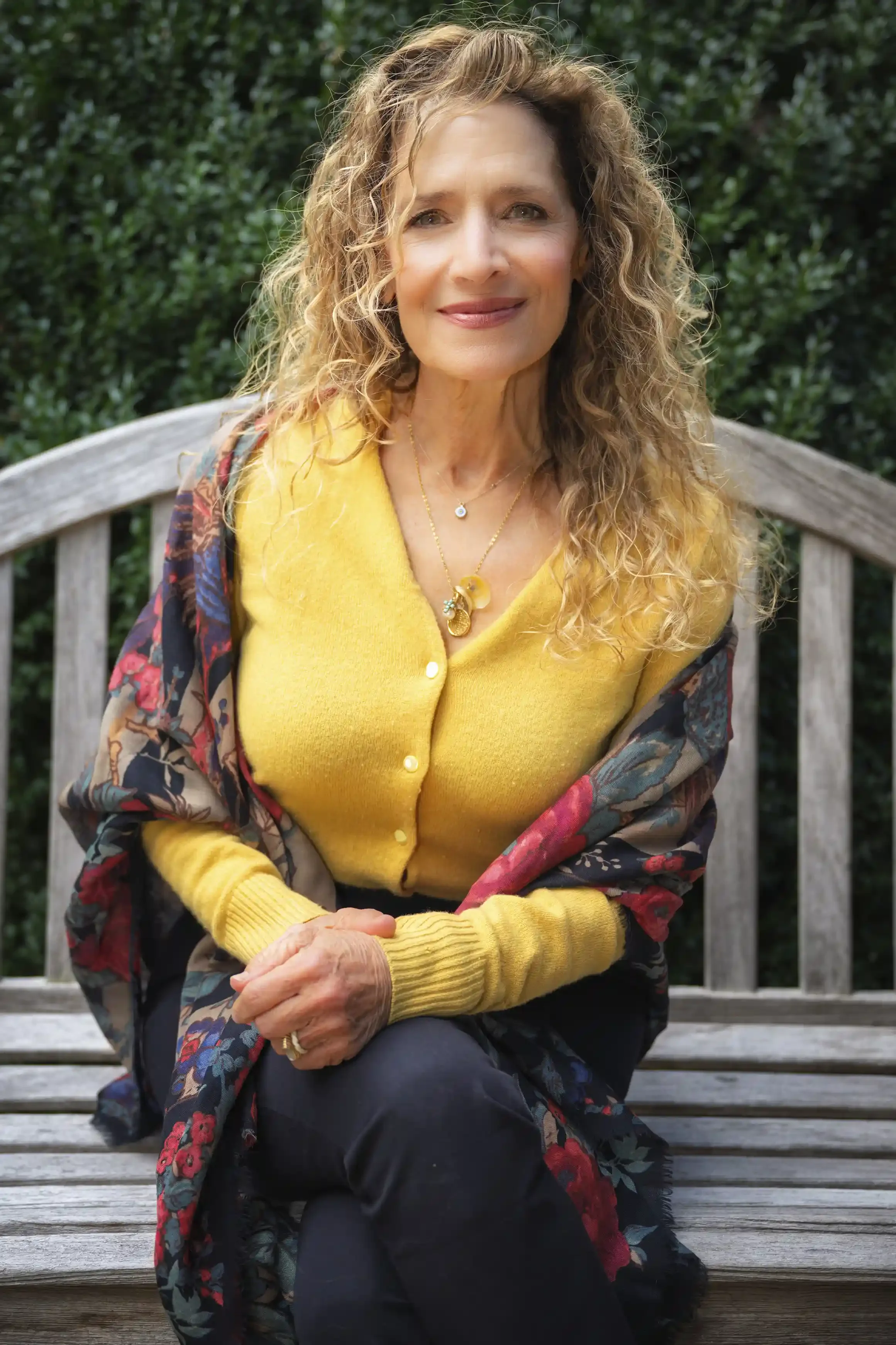 Konstantina Zaras seated in front of boxwood