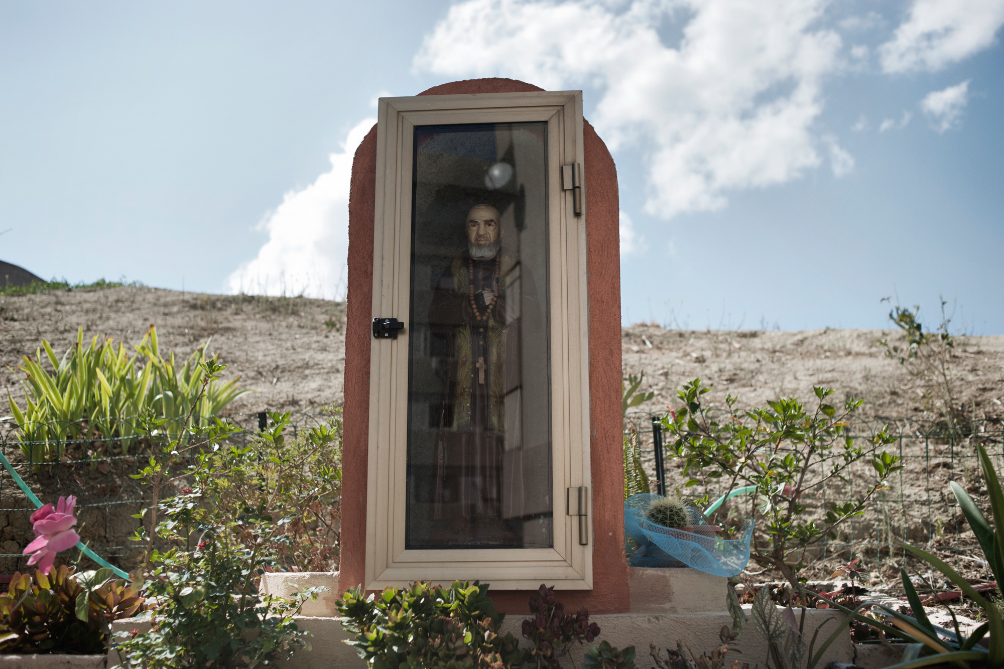  Italia. Crotone 2013: Un'icona di Padre Pio nel vecchio quartiere operaio. 