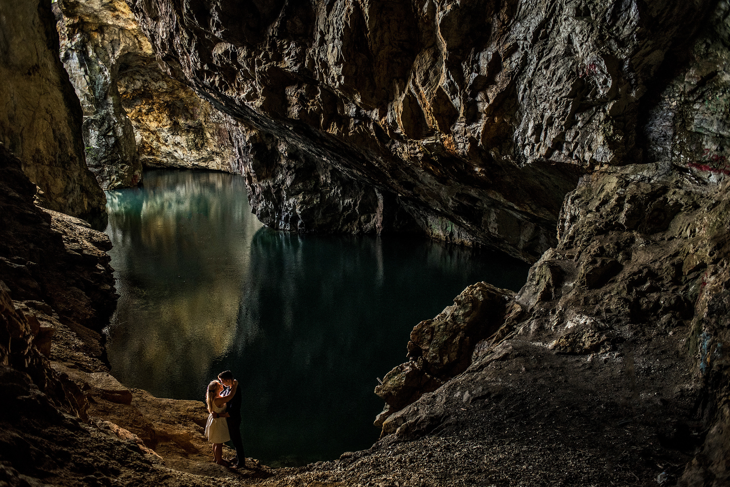 a couple having an engagement portrait in a cave