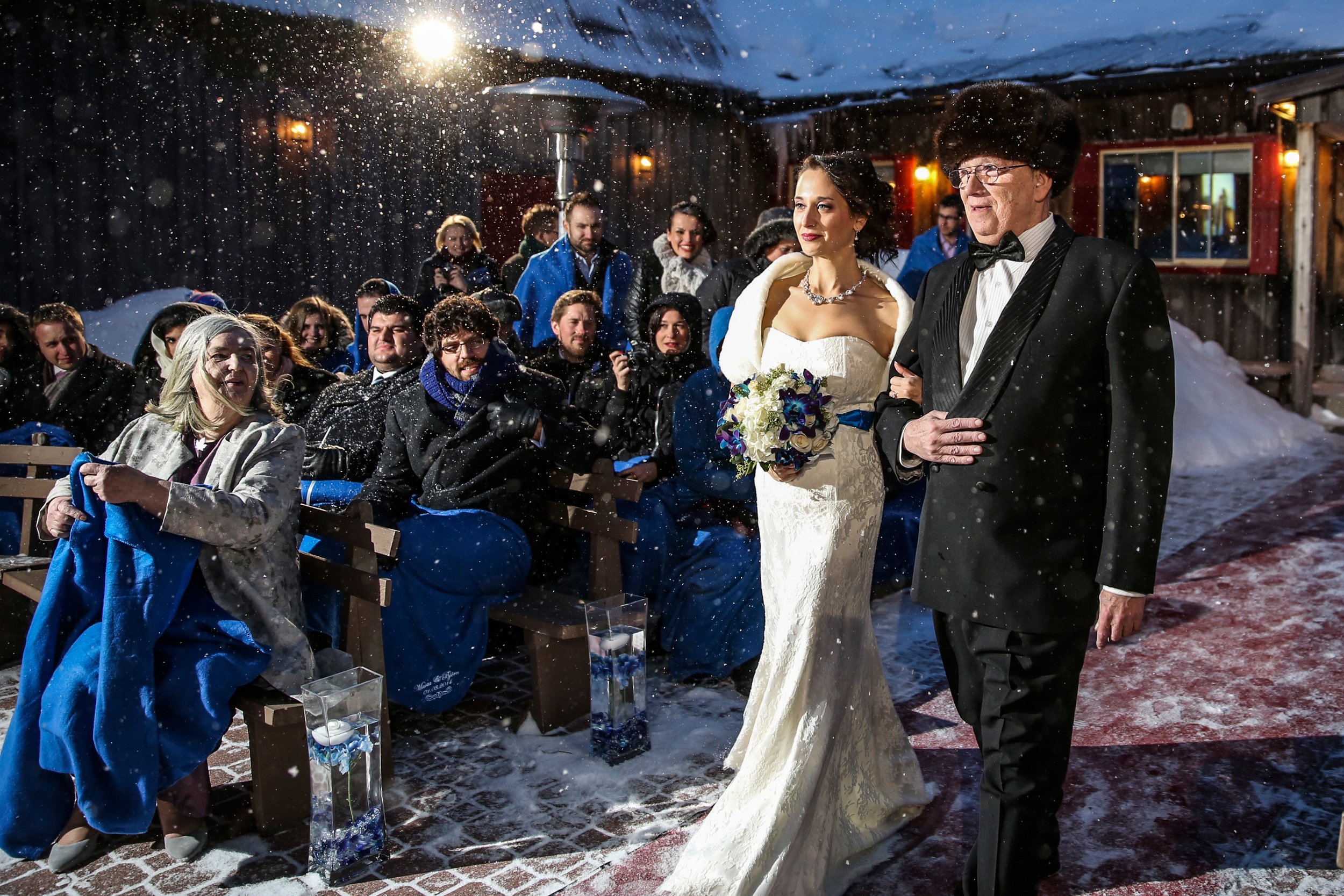 bride and father walk down aisle during a winter wedding ceremony at strathmere