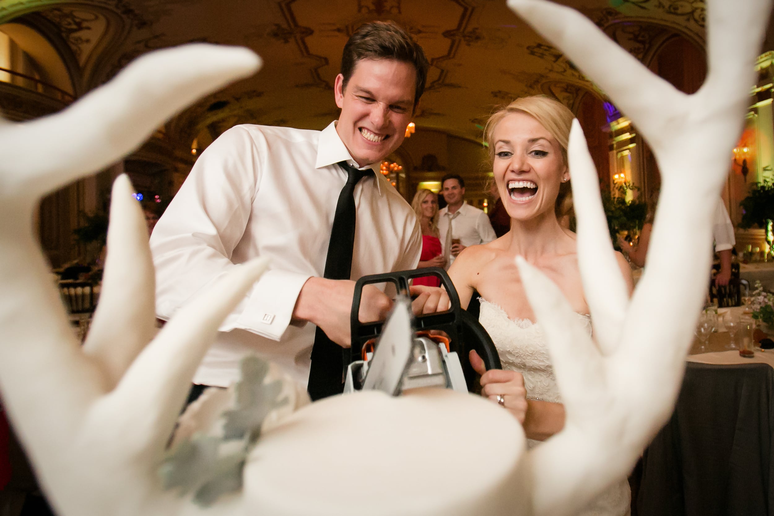 bride and groom cutting their cake with a chainsaw (Copy)