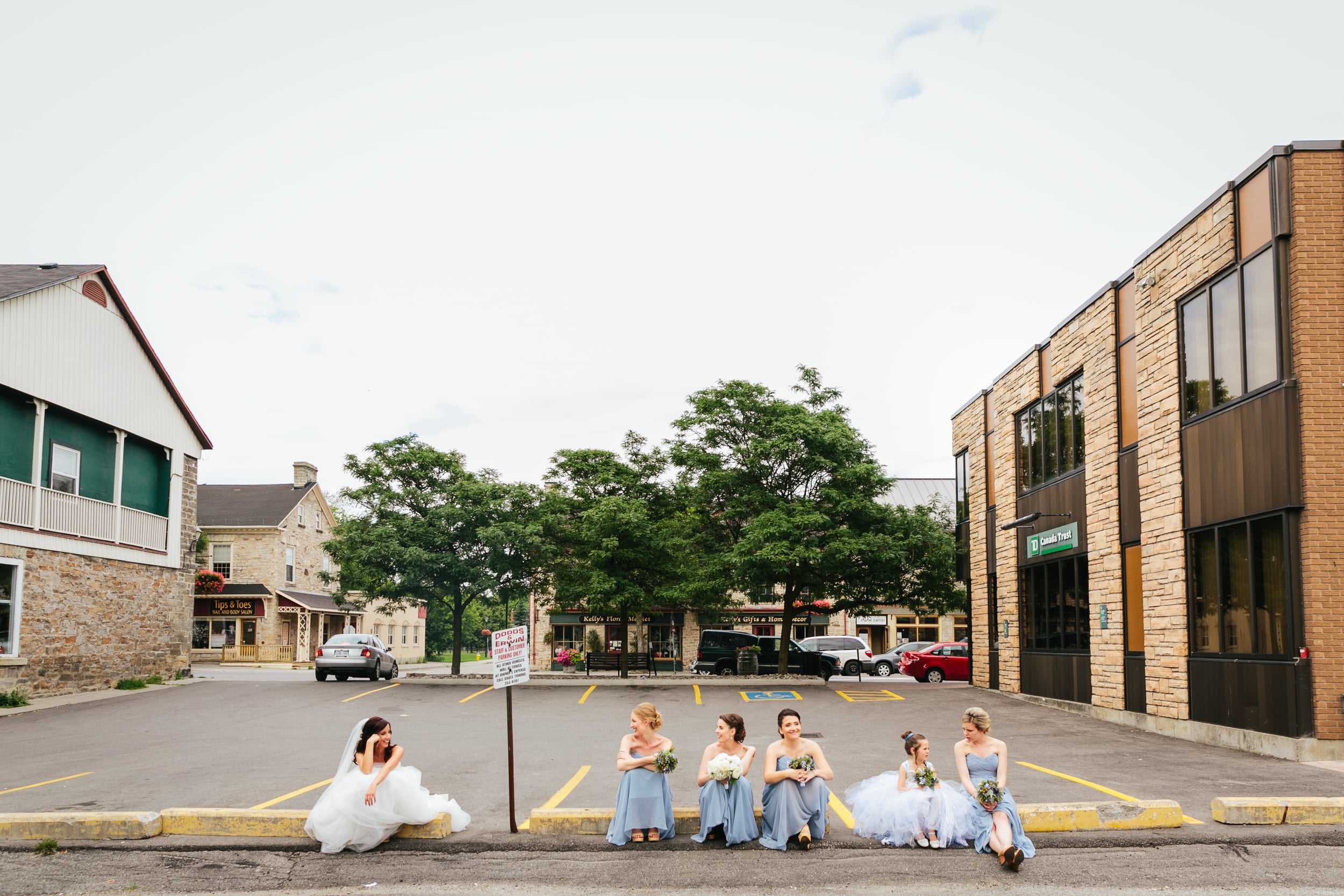 bridesmaids and brides sitting on a curb in perth (Copy)