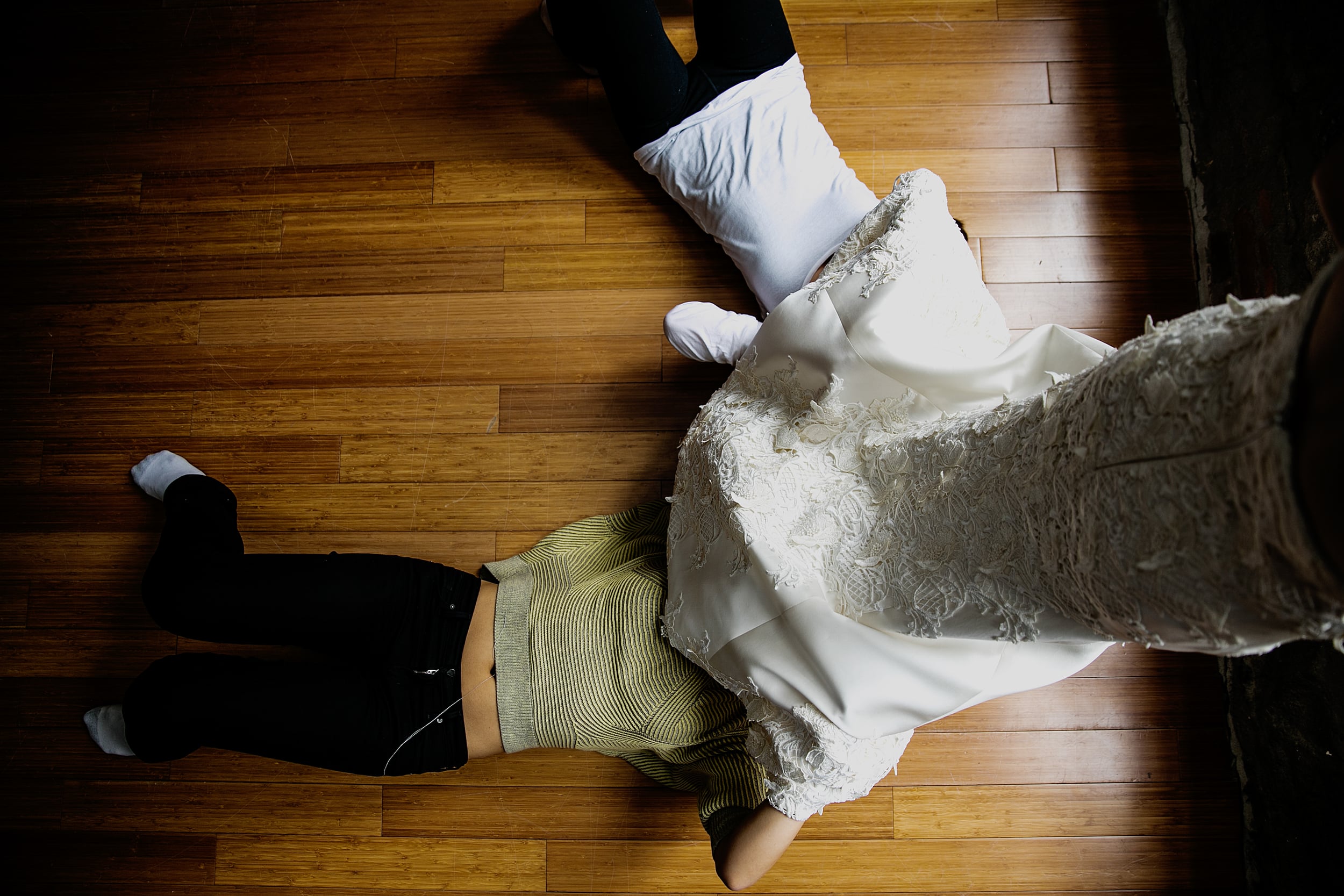 two bridesmaids fix a wedding dress (Copy)