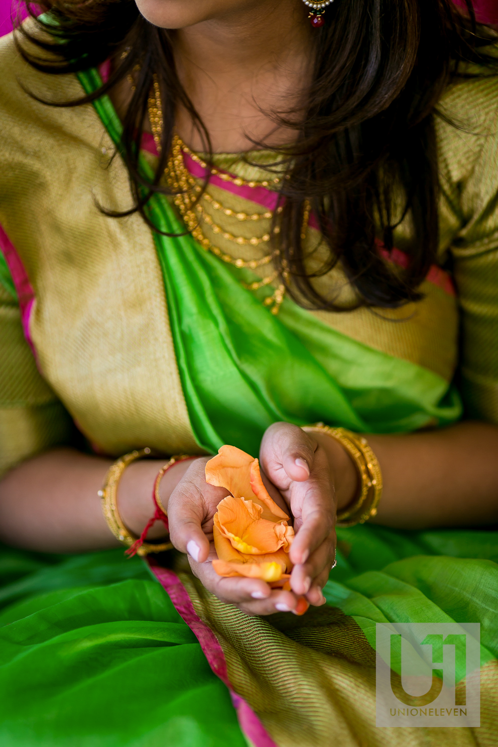  indian bride holding flower petals at a hindu ceremony 
