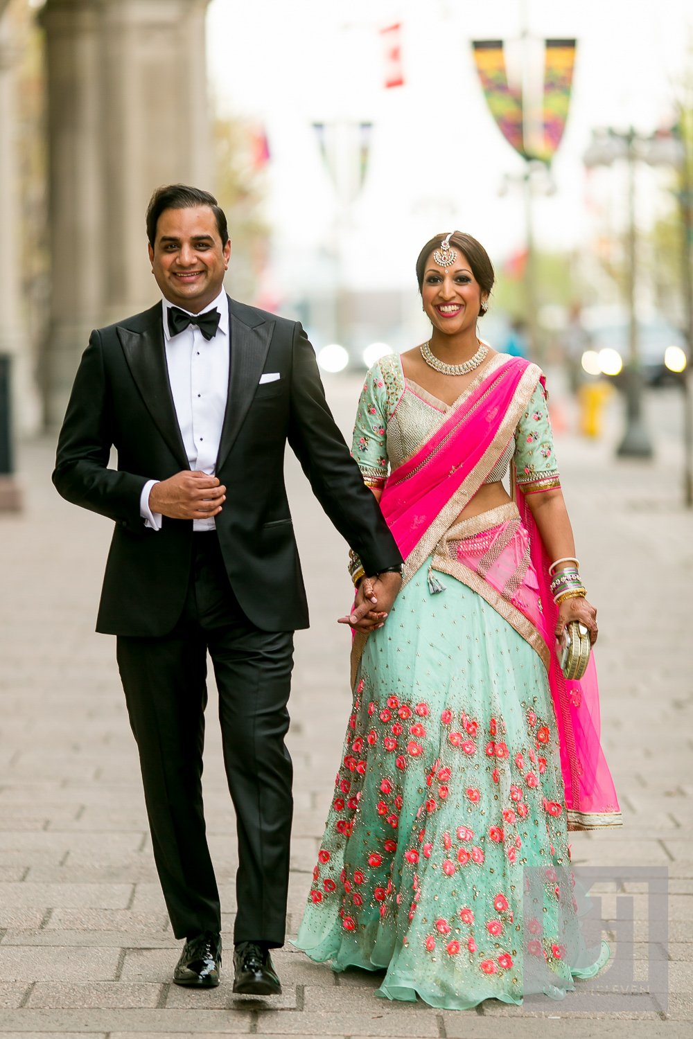  indian couple walking outside of the chateau laurier on their wedding day 