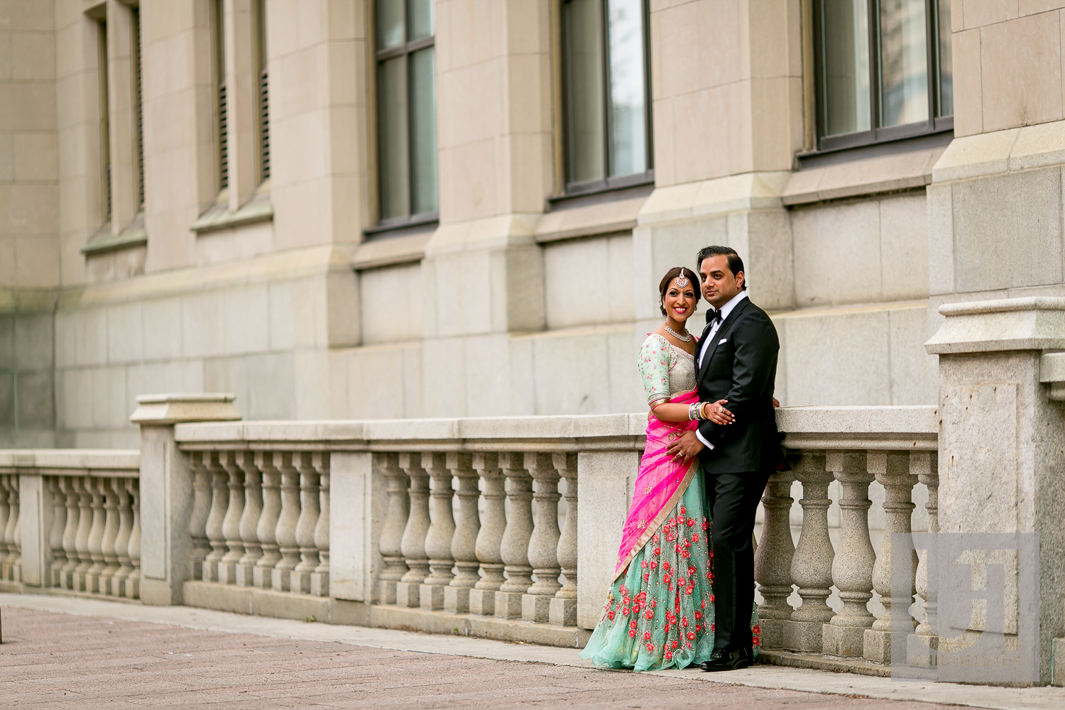 indian couple outside of the chateau laurier on their wedding day