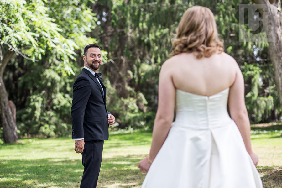 groom-turning-to-face-bride-in-gown-for-first-look-prior-to-wedding-in-ottawa