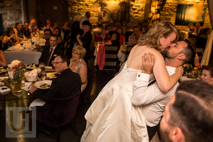 groom-lifting-bride-while-kissing-during-wedding-reception-at-eighteen-restaurant-in-ottawa