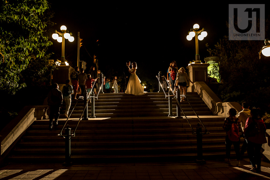 night-time-portrait-of-bride-and-groom-amongst-crowd-in-downtown-ottawa-market