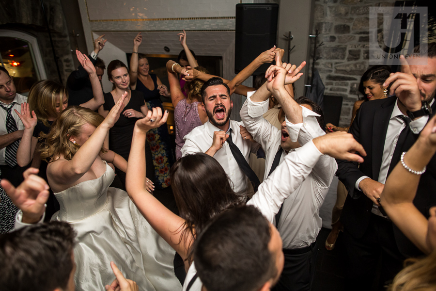 large-crowd-of-guests-dancing-during-wedding-reception-at-eighteen-restaurant-in-ottawa