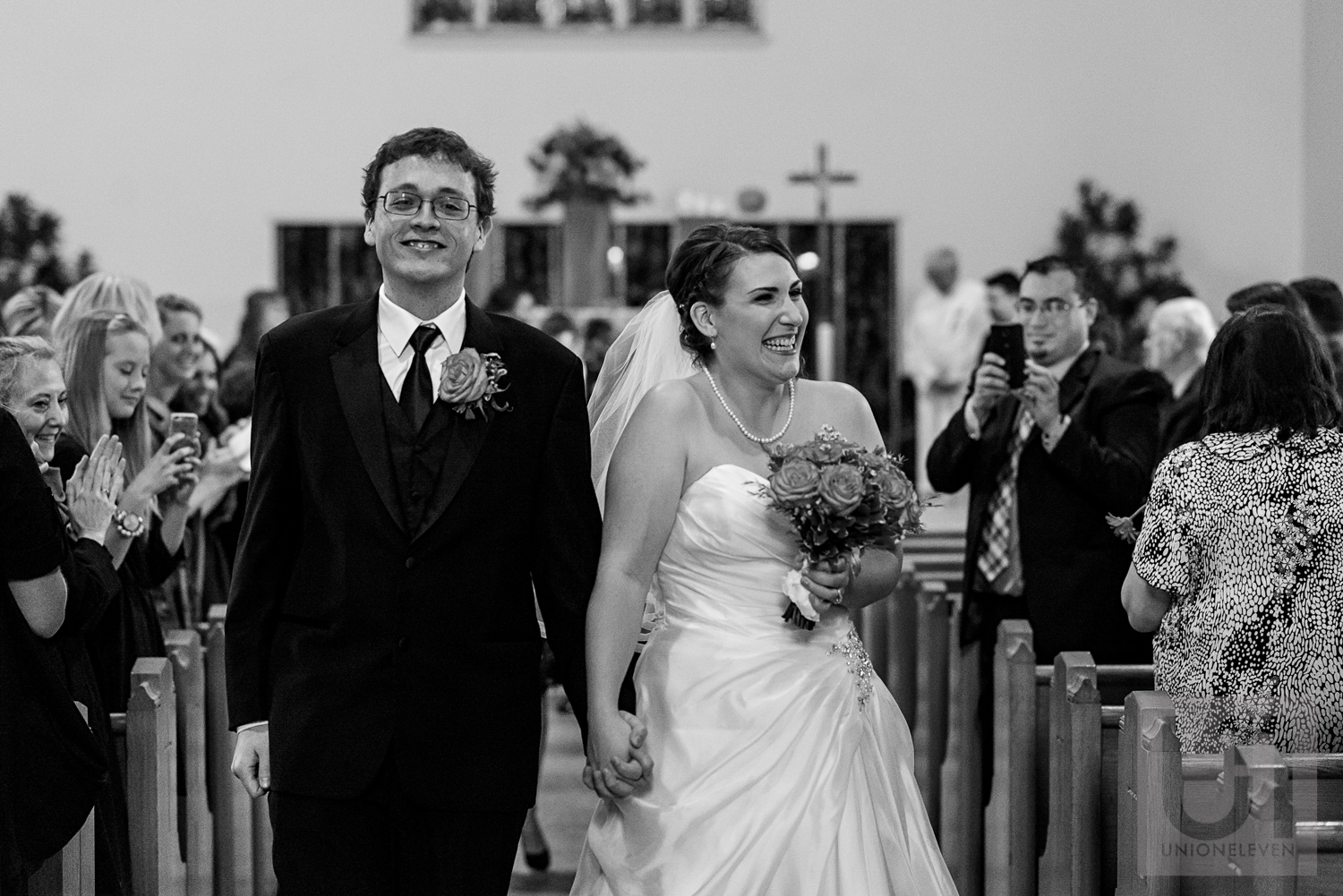 The bride and groom walking down the aisle as husband and wife