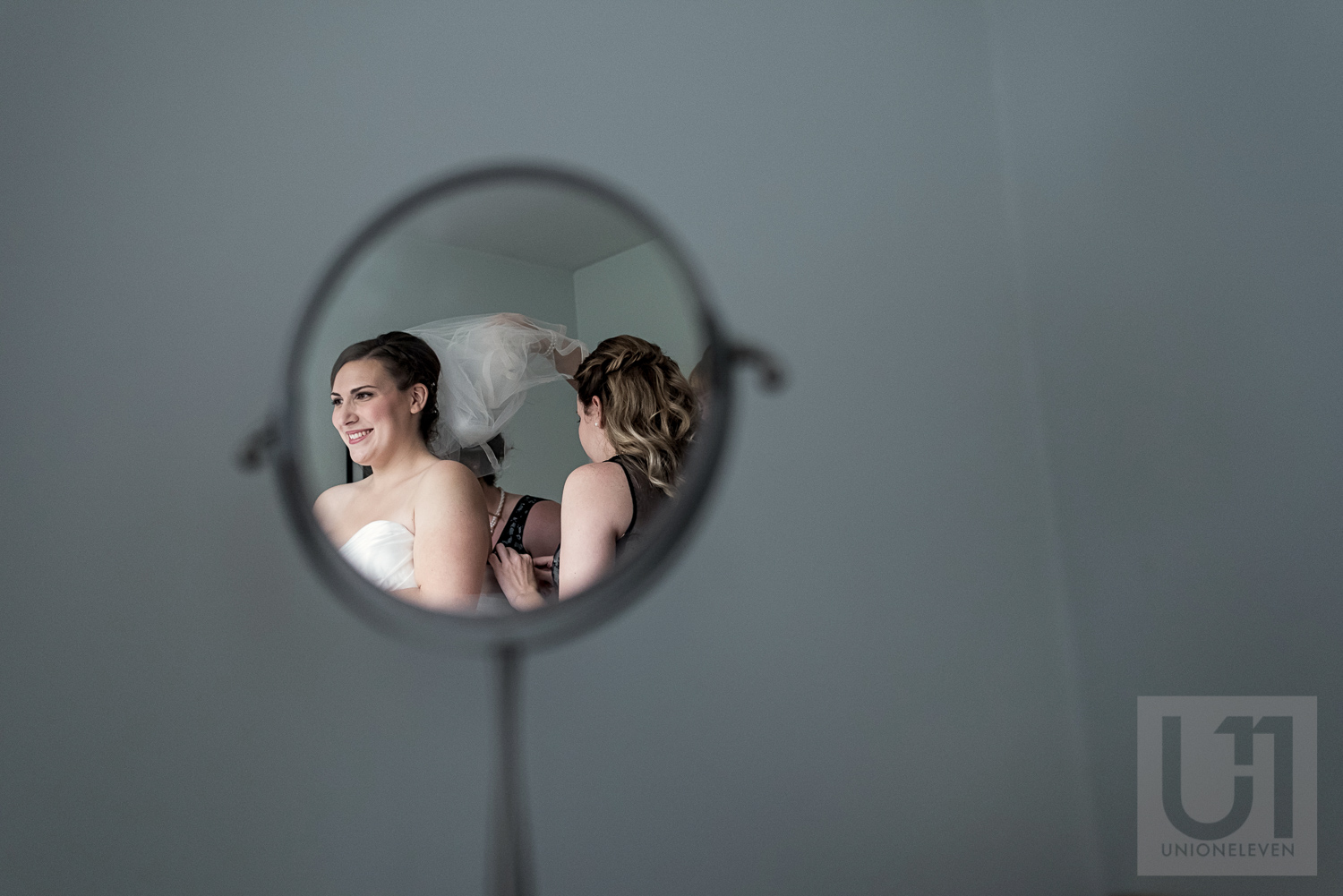 The bridesmaids together helping the bride with her veil
