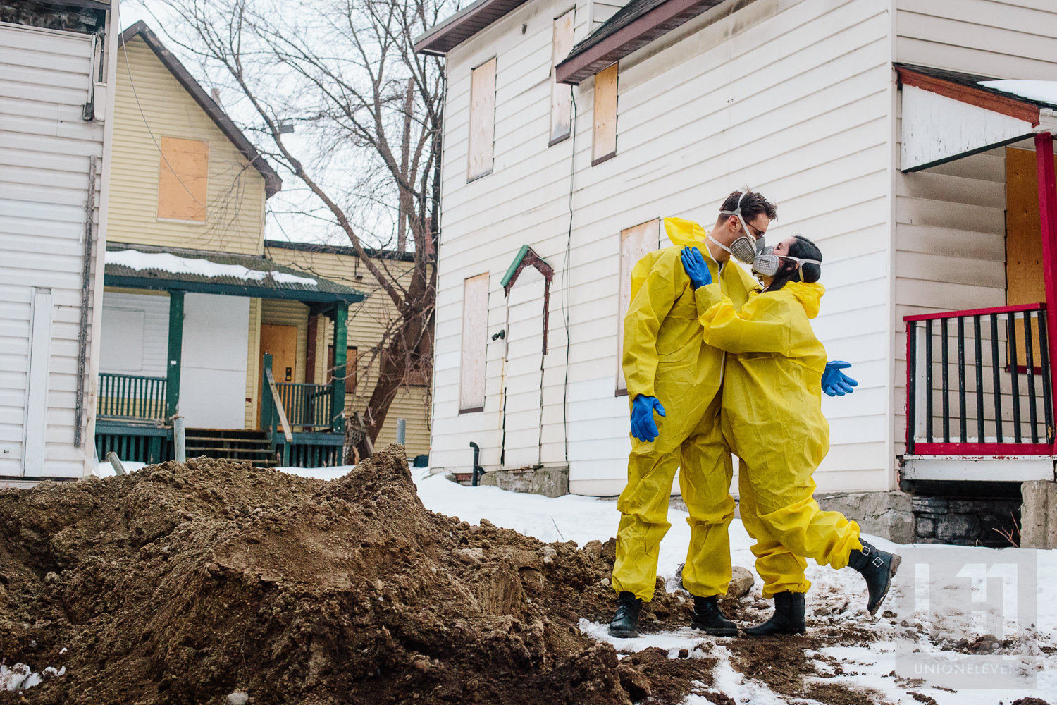 Engagement shoot with the couple hugging in their hazmat suits