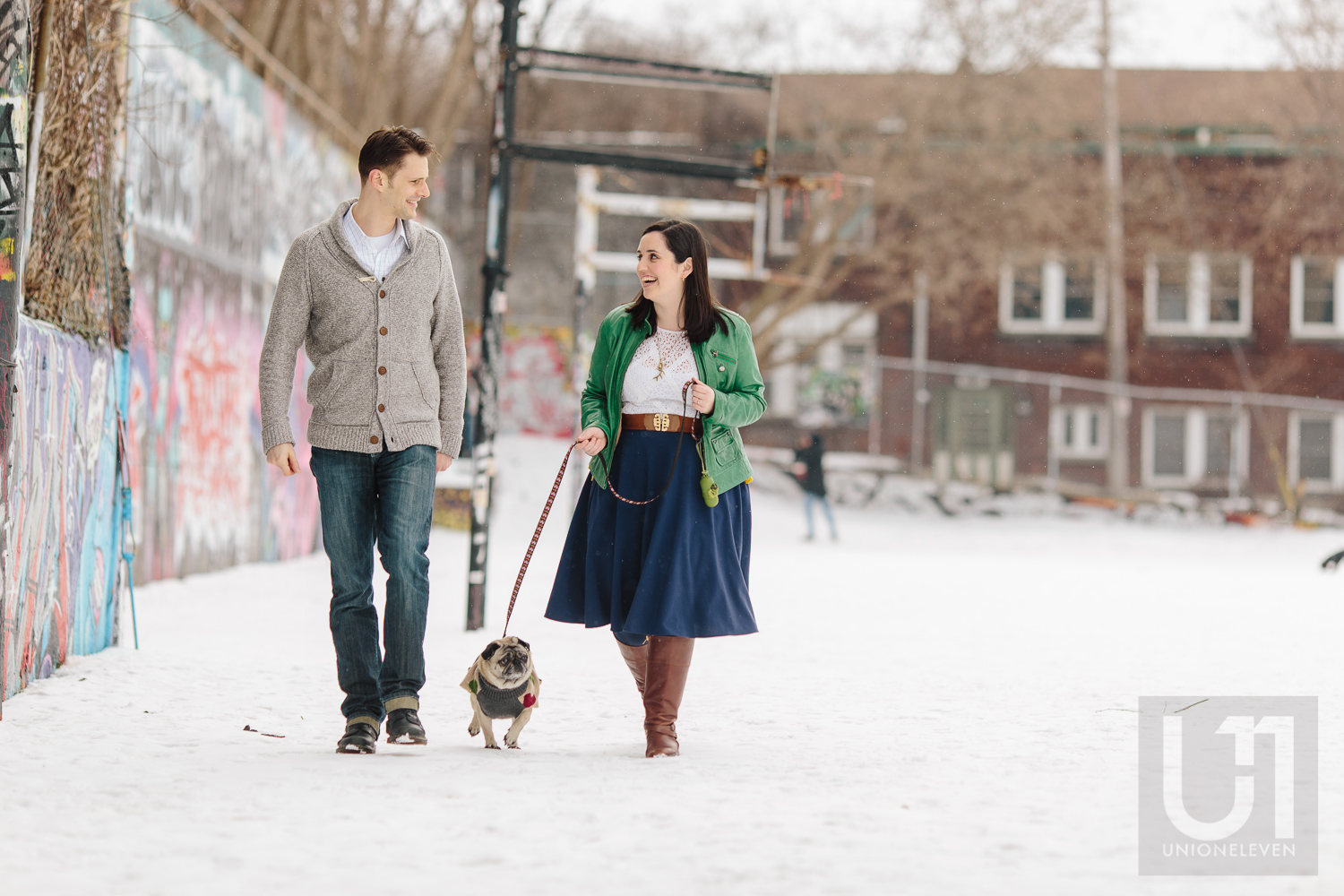 Engagement shoot with the couple walking their pug in the park