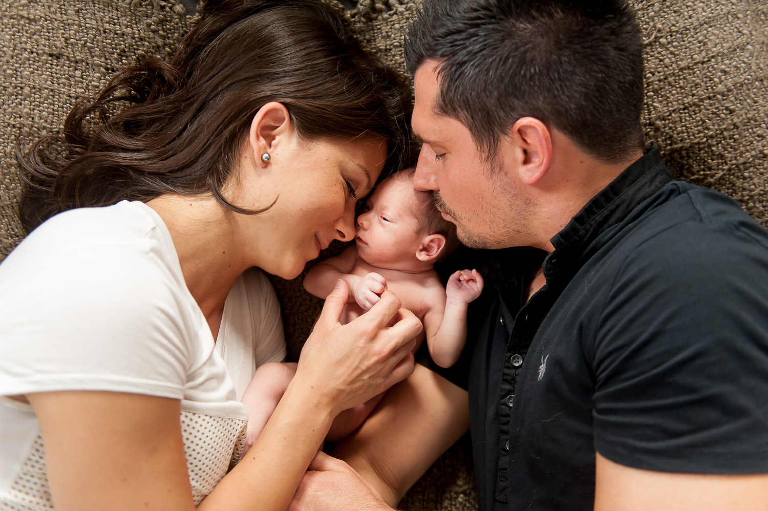 photograph of new parents snuggling their baby (Copy)