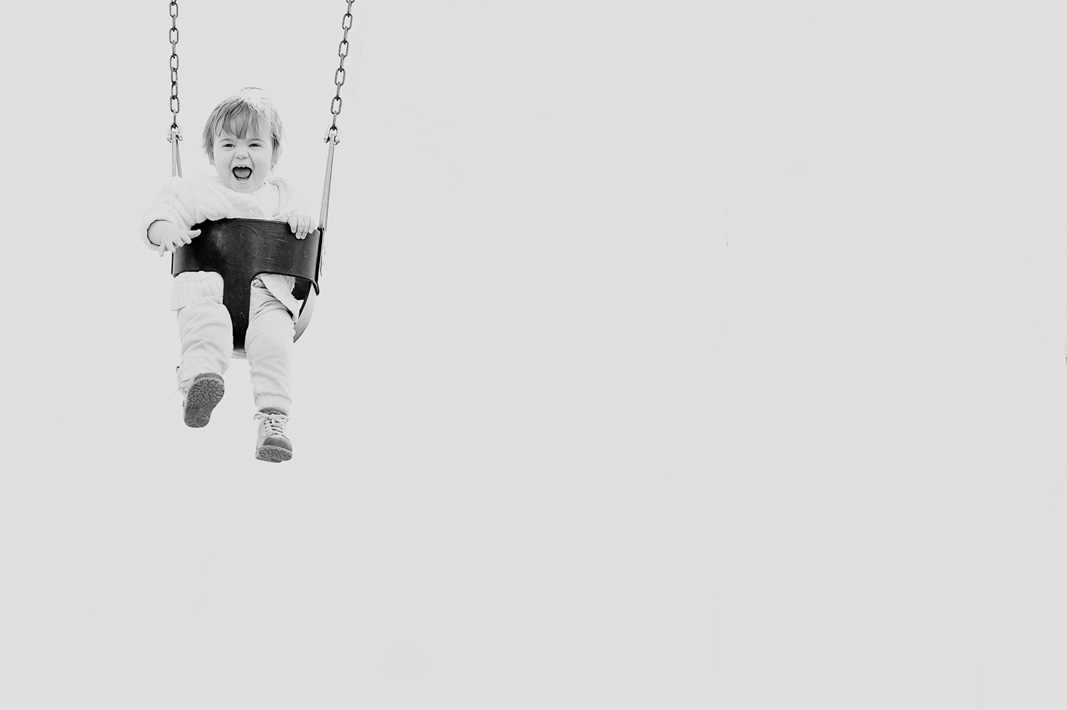 photo of a little baby having fun on a swing (Copy)