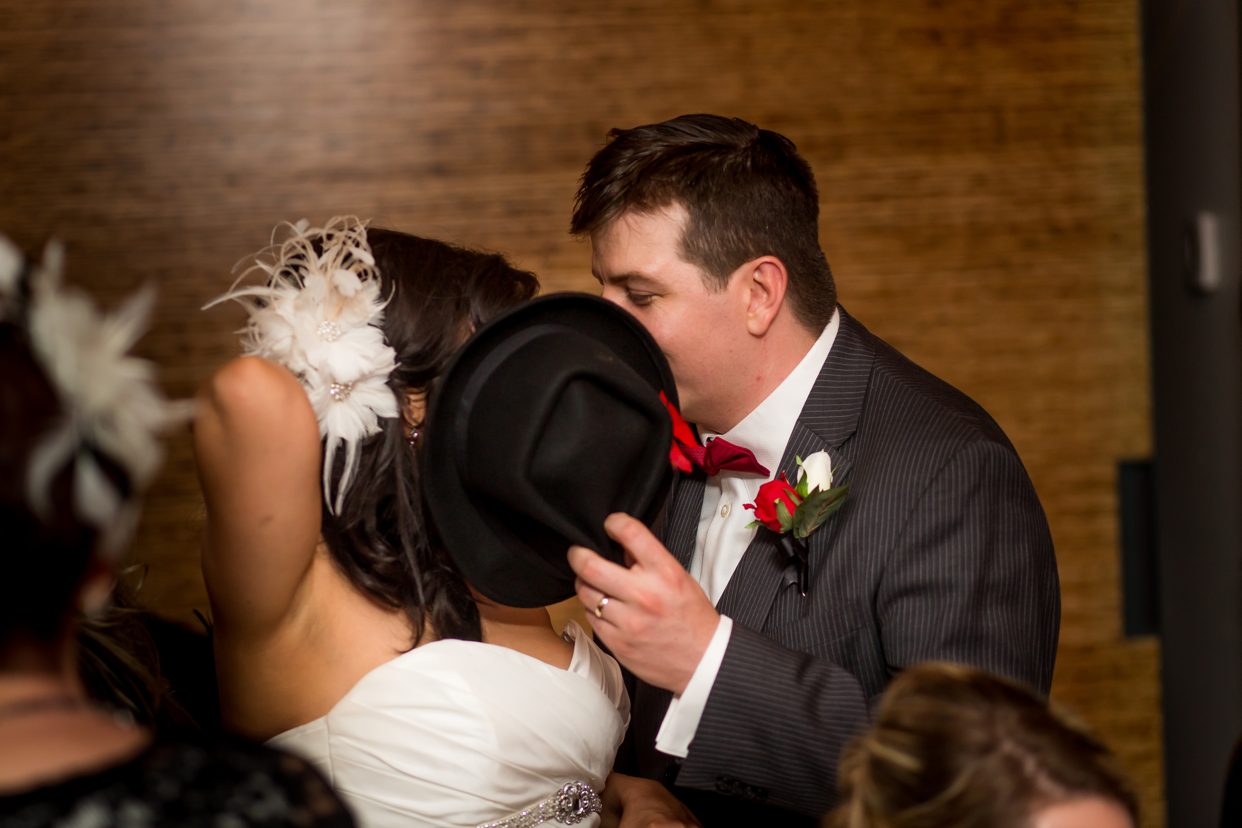 The bride and groom sneaking a kiss at their wedding reception