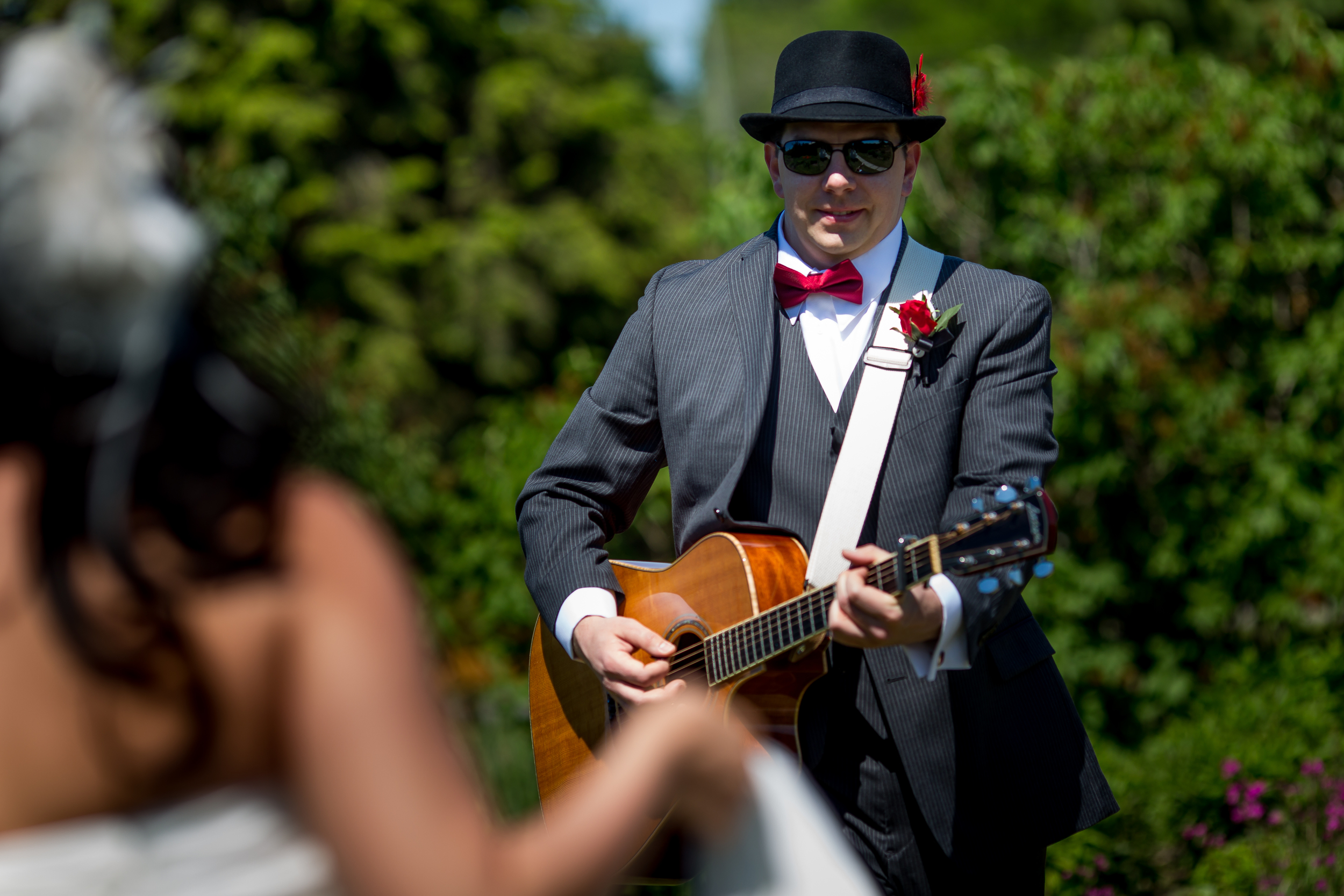 The groom playing the guitar for his bride