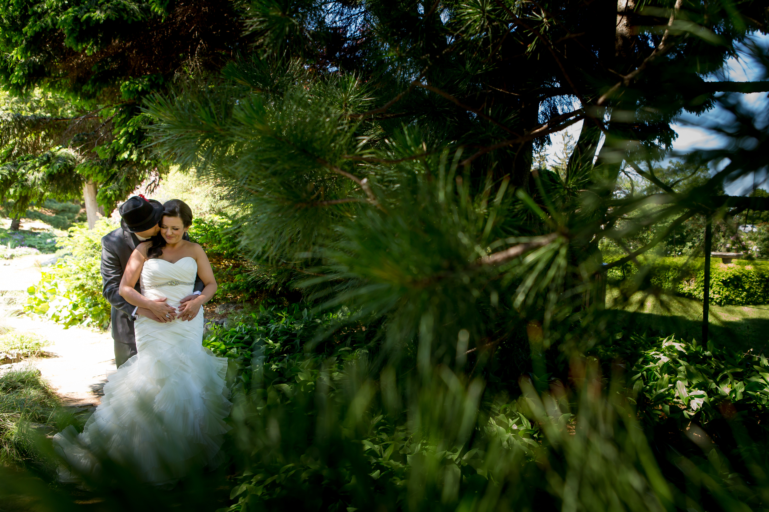 A photo of the bride and groom amongst the trees at the Experimental Farm