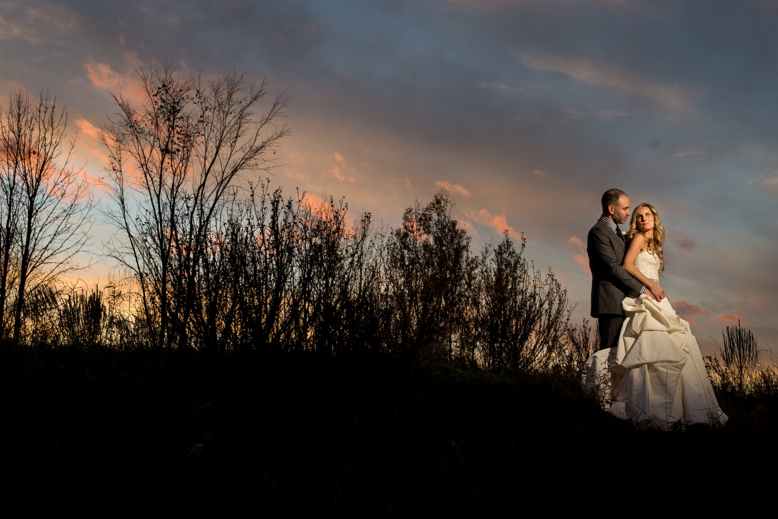 A portrait of the bride and groom outside at dusk at Stonefields