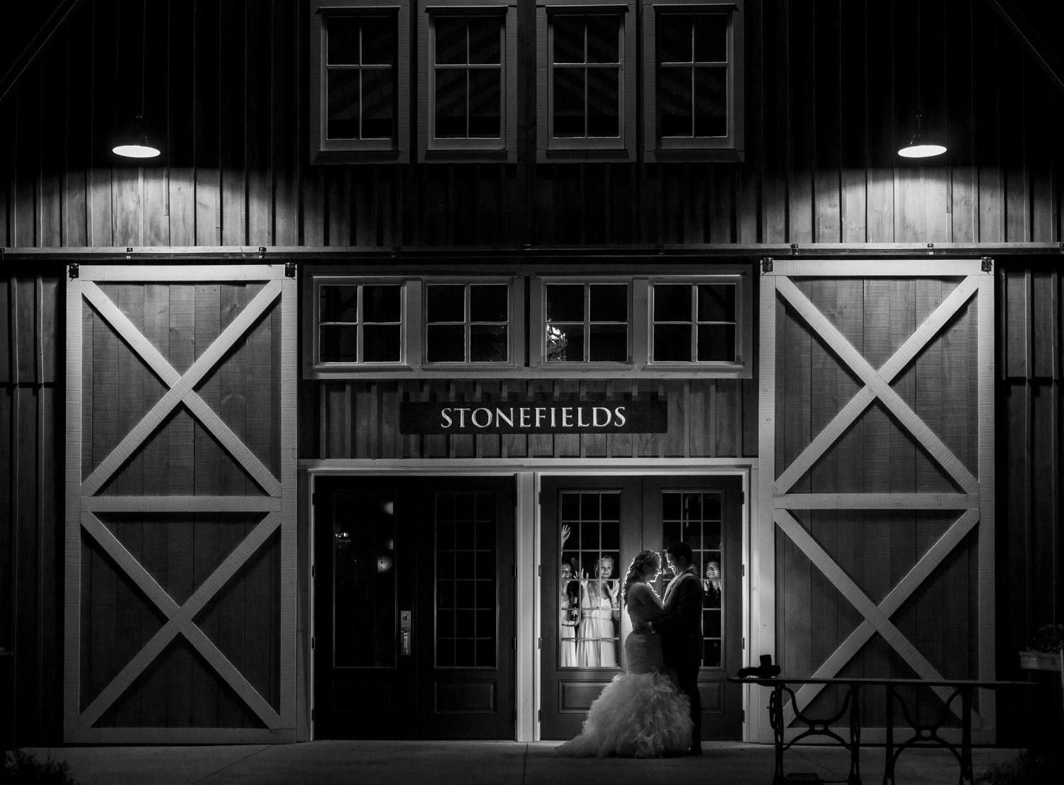 A night time portrait of the bride and groom outside the Stonefields Loft