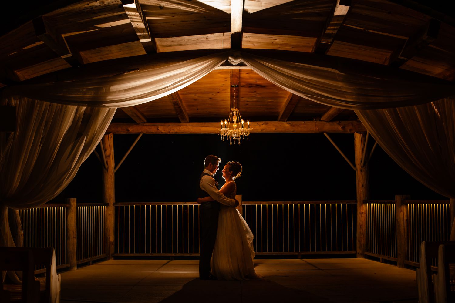 A night time portrait of the bride and groom outside at Le Belvedere