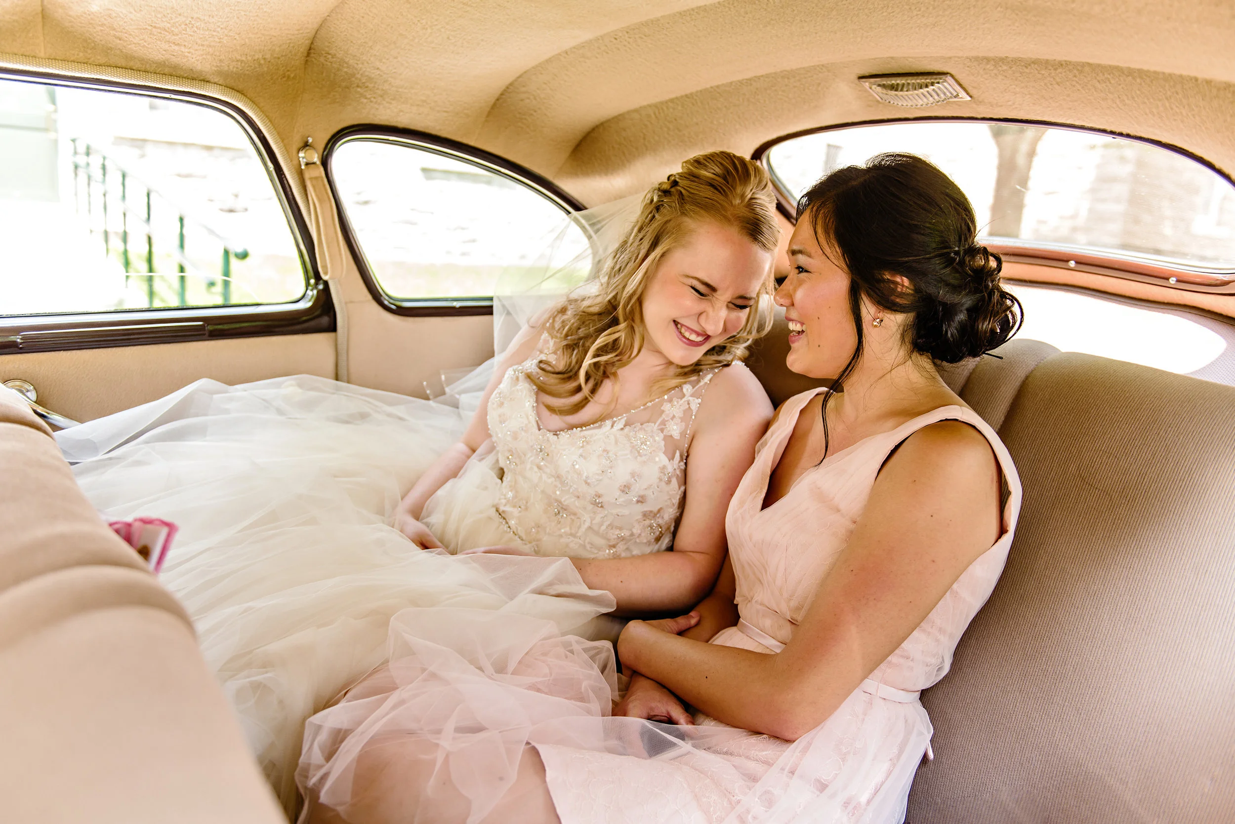 bride-and-bridesmaid-have-a-moment-in-the-limo-before-a-st-patricks-wedding-in-richmond-ontario.jpg