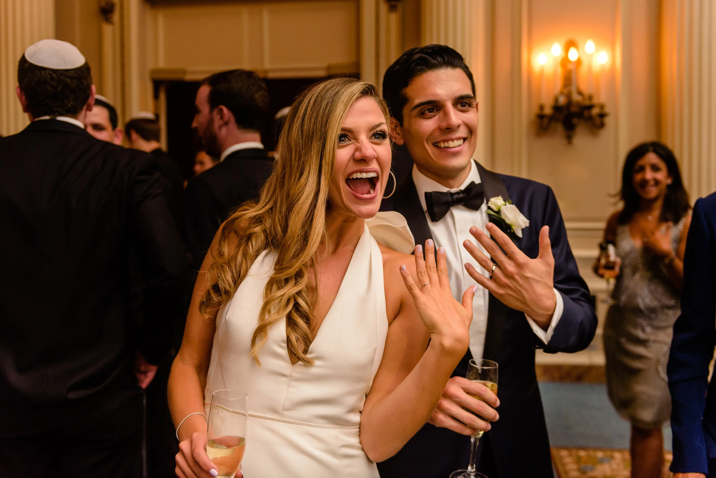 bride-and-groom-show-off-their-new-wedding-rings-during-a-wedding-reception-at-a-fairmont-chateau-laurier-in-ottawa.jpg