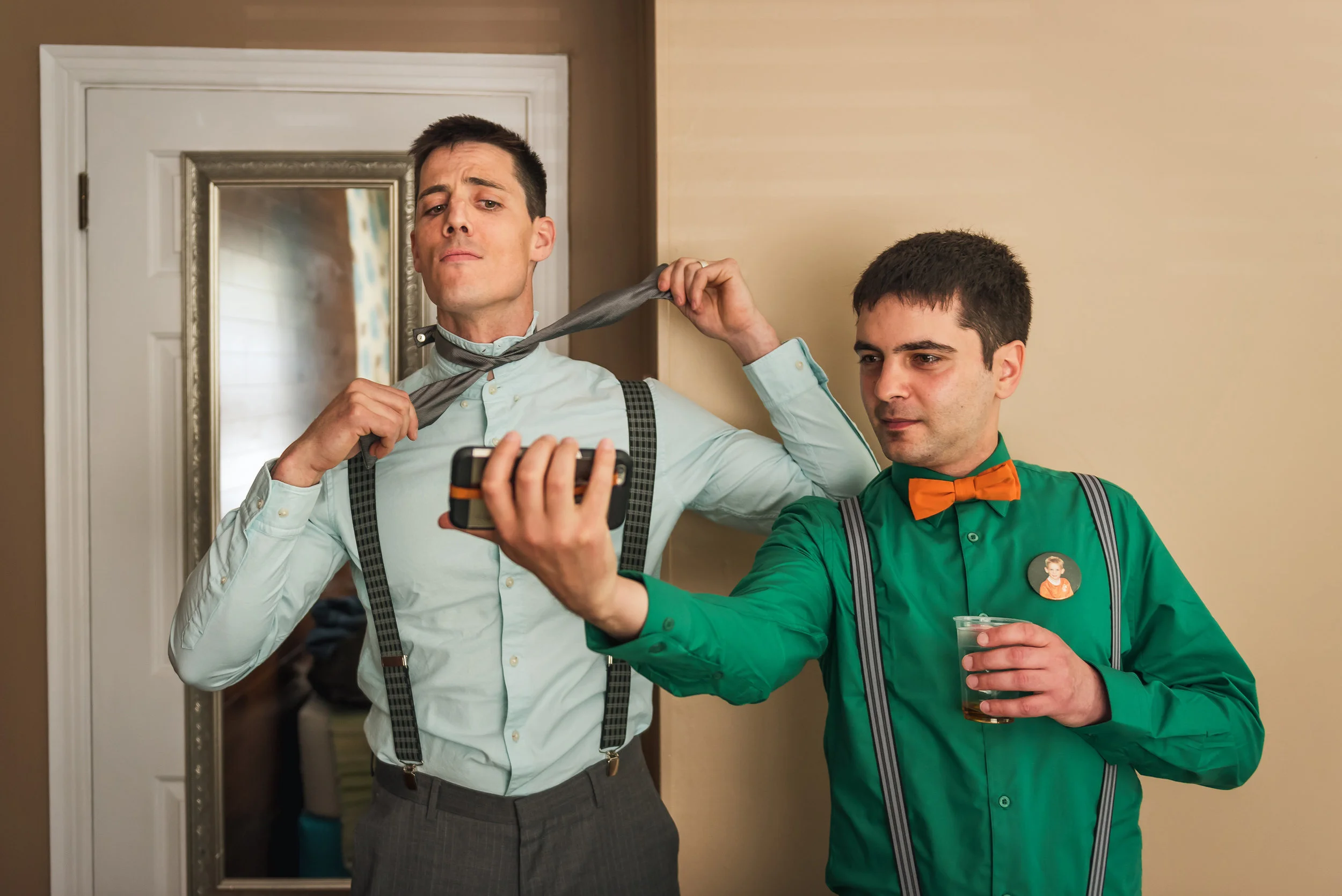 groom-watching-how-to-a-tie-video-while-getting-ready-for-his-museun-of-nature-wedding-in-ottawa-ontario.jpg