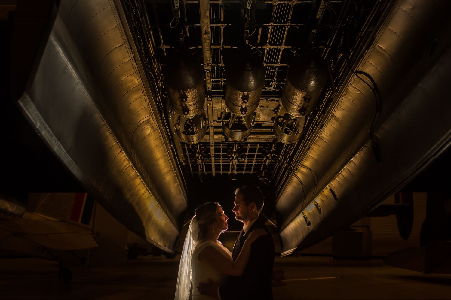 A night time portrait of the bride and groom taken inside the Canadian Aviation and Space Museum in downtown Ottawa