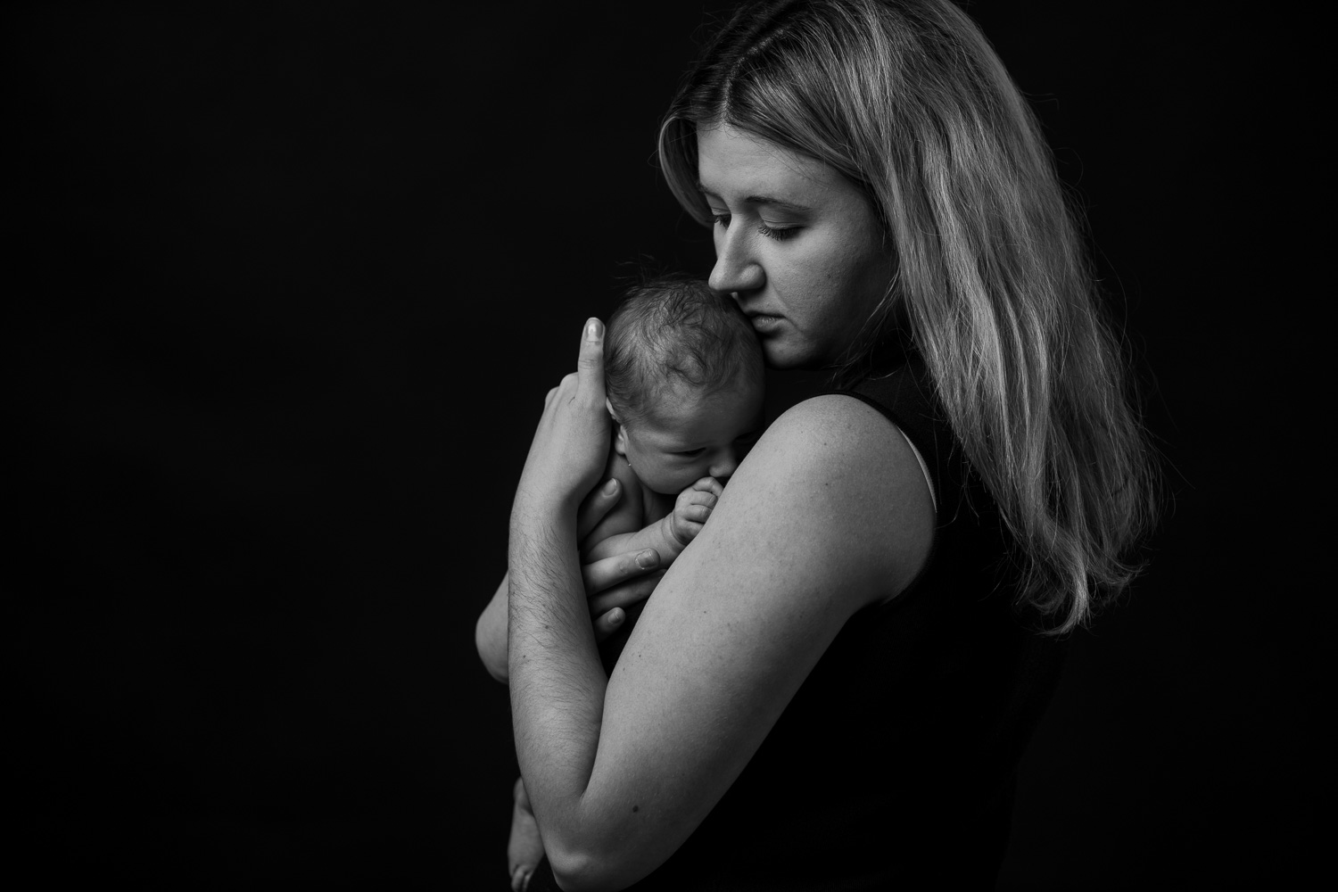 portrait of a mother and her new baby