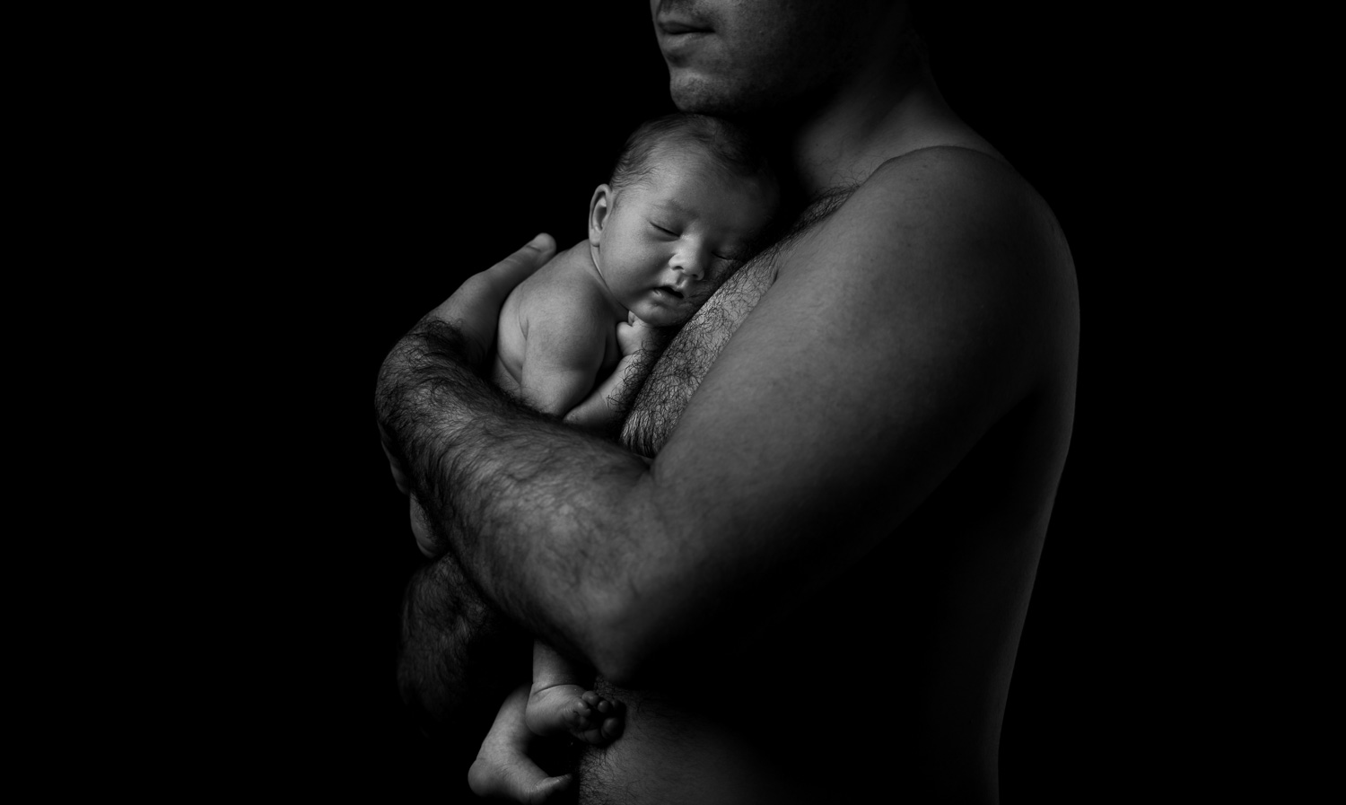 black and white in-studio photograph of a dad with his newborn baby (Copy)