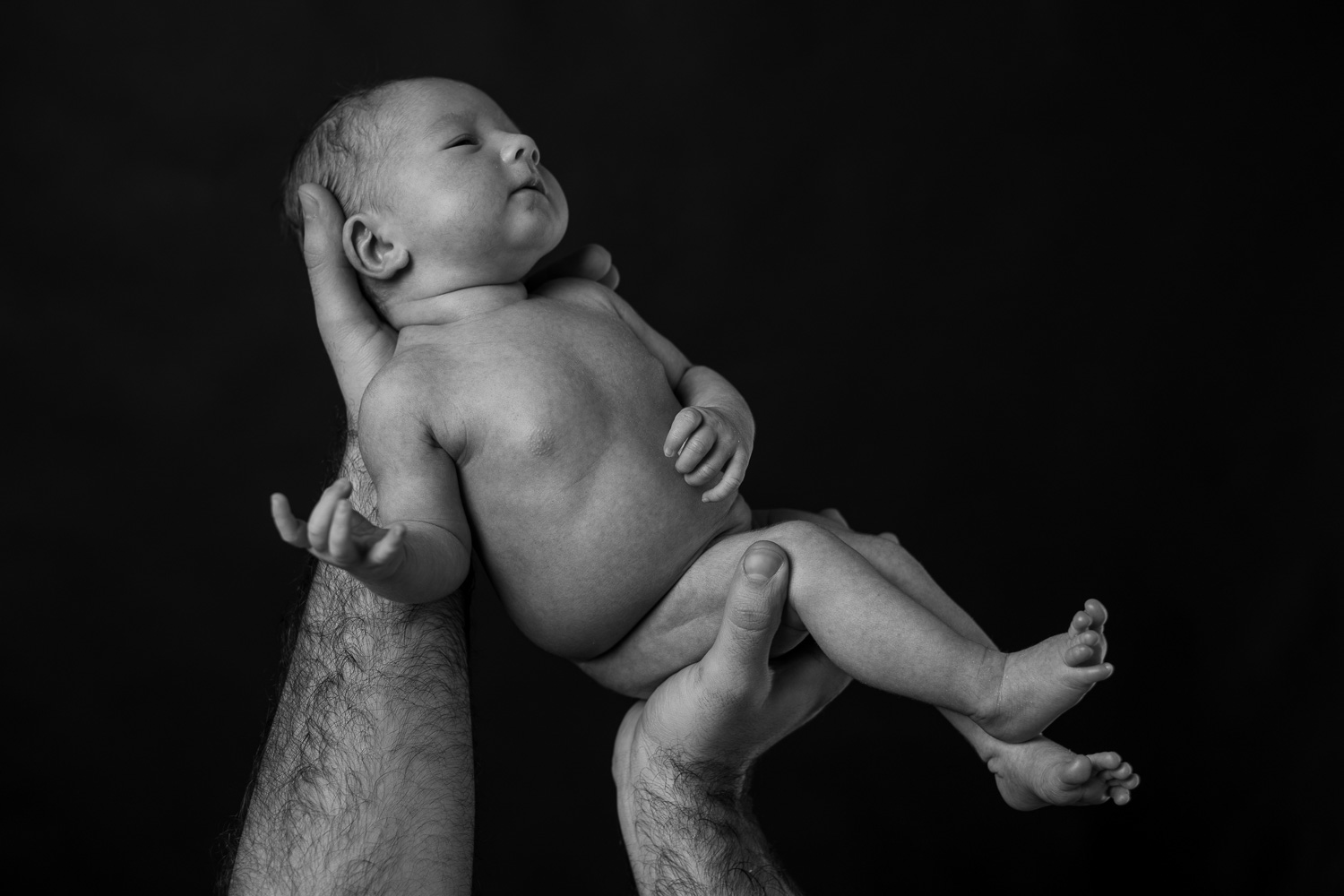 Photograph of a newborn baby on a black backdrop (Copy)