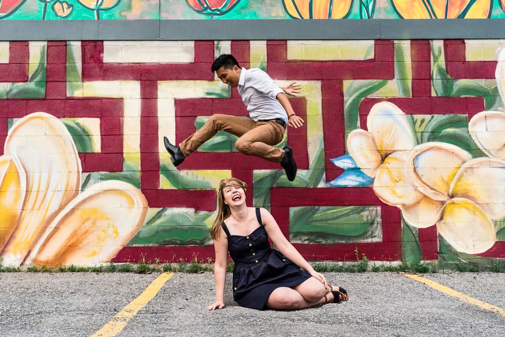 a funny engagement photo with the guy jumping over the girl (Copy)