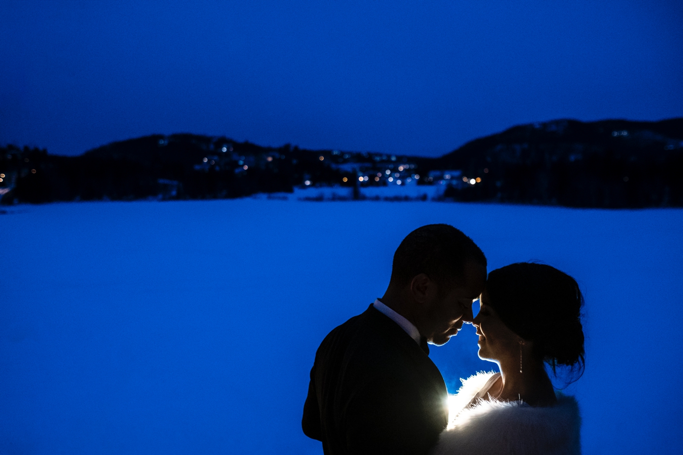 a nighttime winter portrait of a bride and groom at the hotel quintessence in mont tremblant quebec