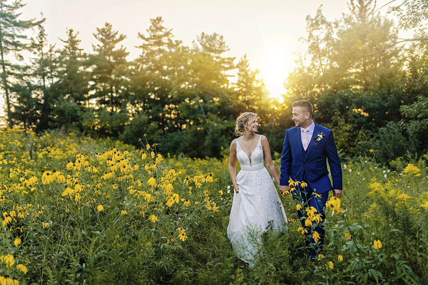 candid moment of bride and groom while taking in a flower field during a wedding at le belvedere in wakefield quebec