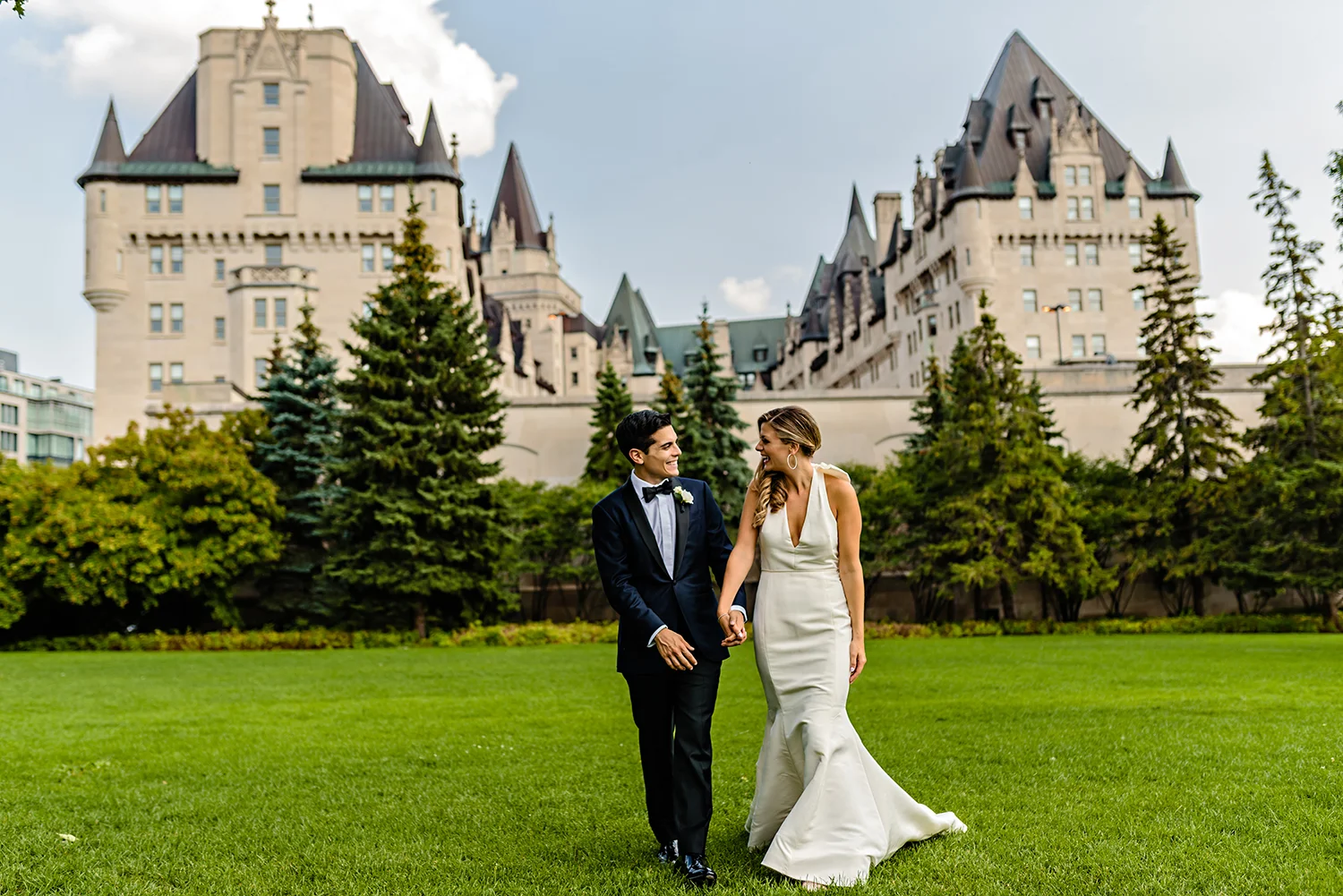candid moment of bride and groom while taking a stroll through major hill park during a wedding at the chateau laurier in ottawa