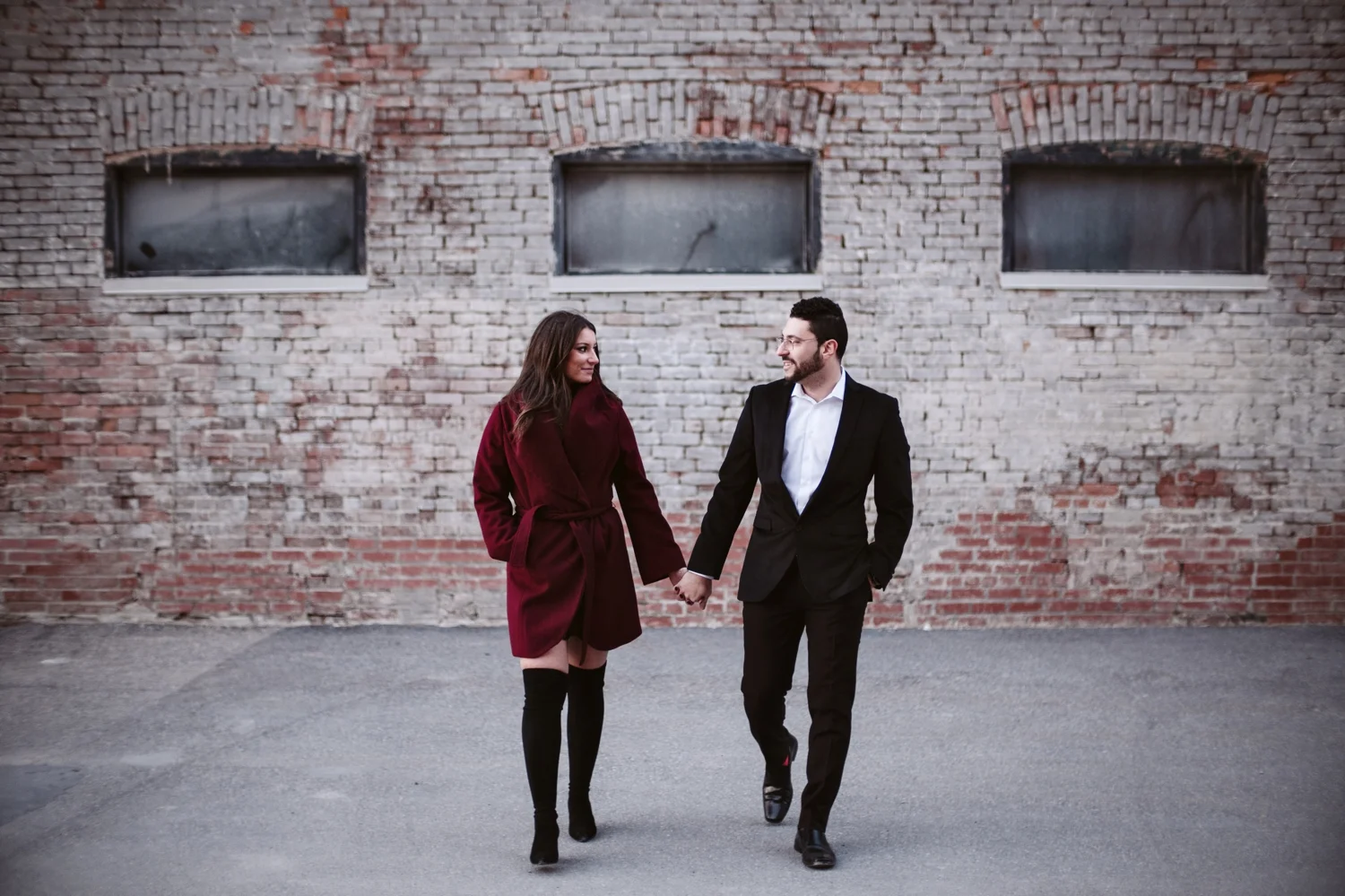 photo of engaged couple walking together near the zibi project in ottawa ontario