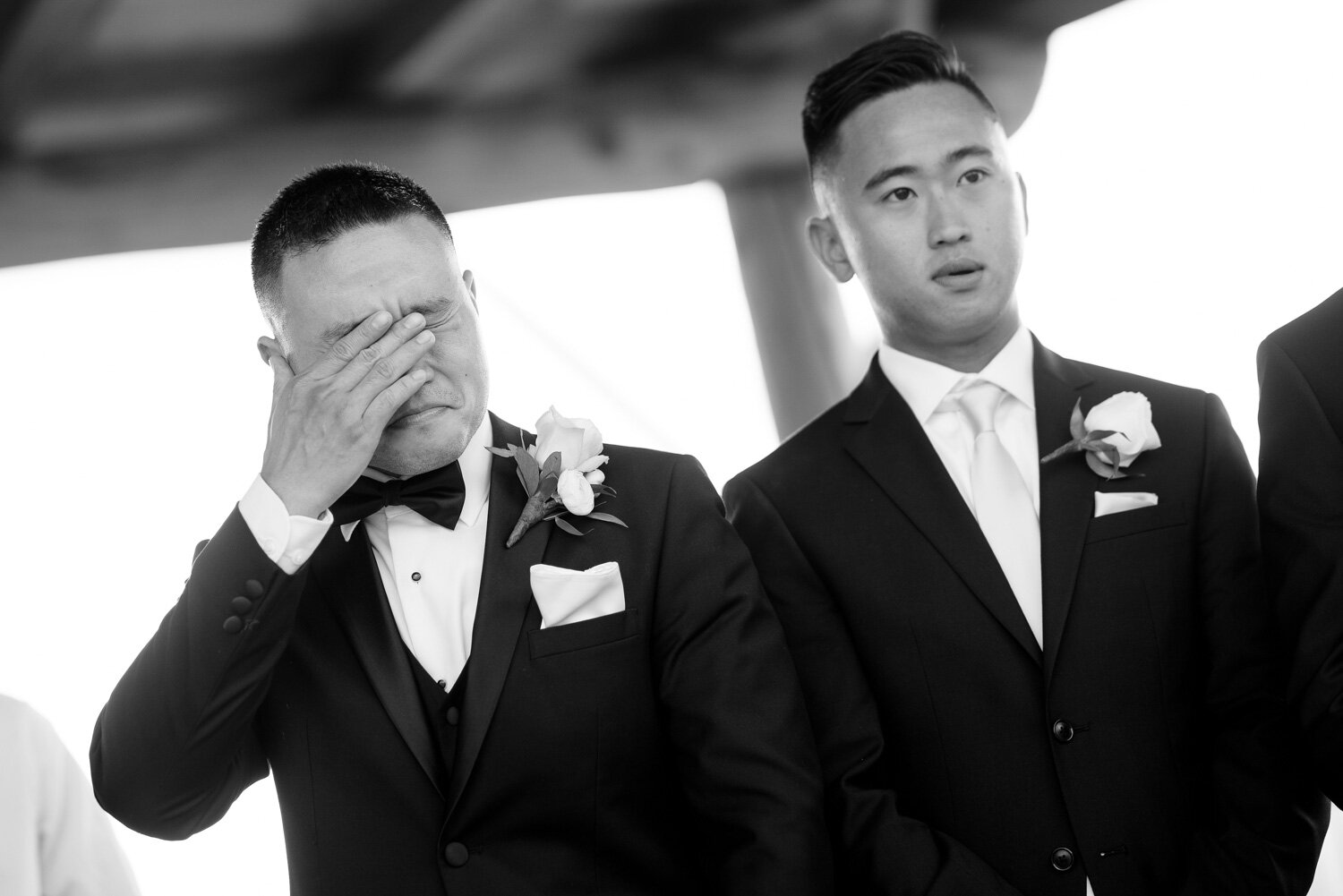 a groom gets emotional seeing his bride walk down the isle at their le belvedere wedding ceremony