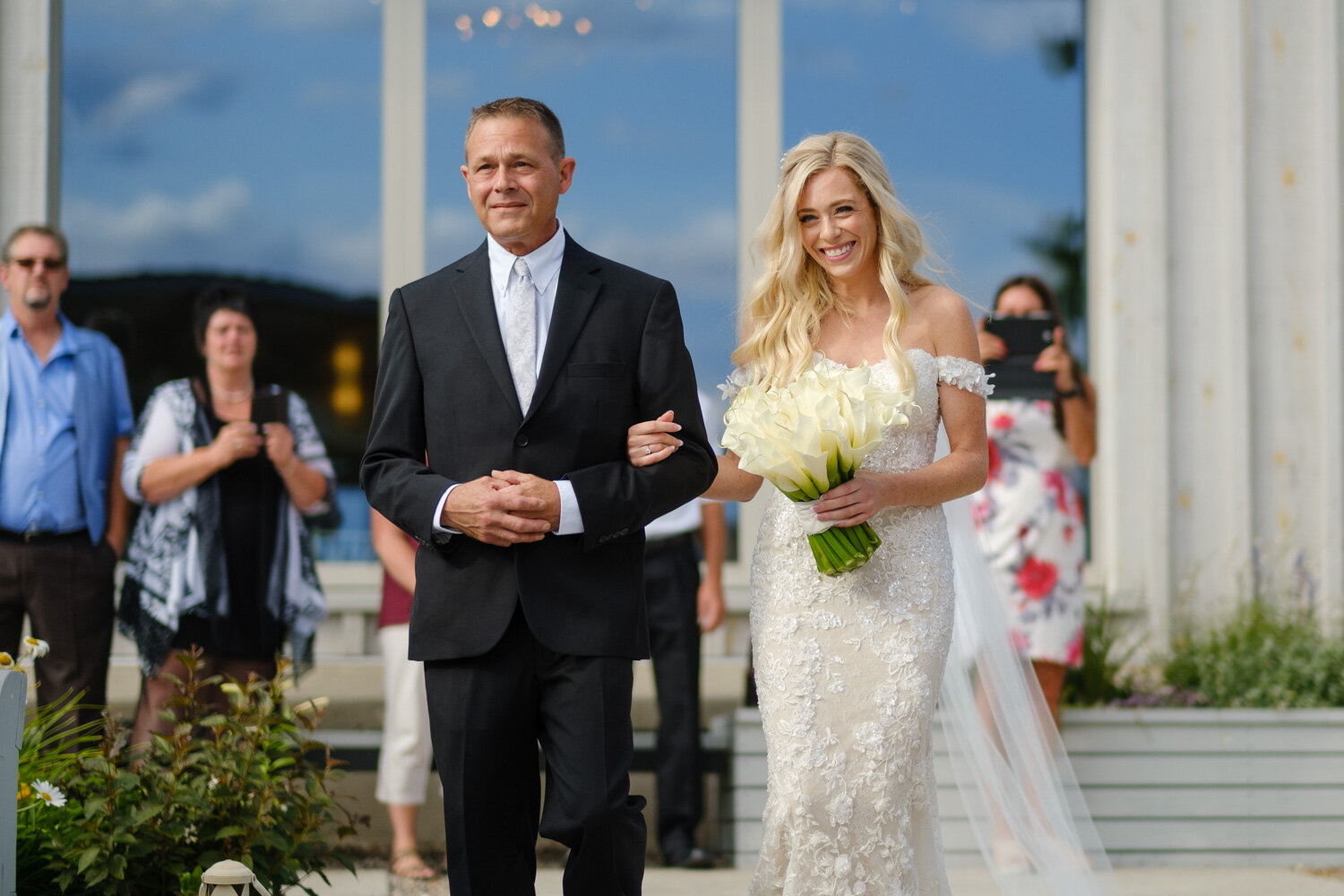 a photo of a bride walking down the isle at her le belvedere wedding ceremony