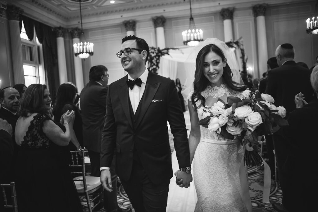 smiling bride and groom walking down the aisle after Chateau Laurier wedding ceremony