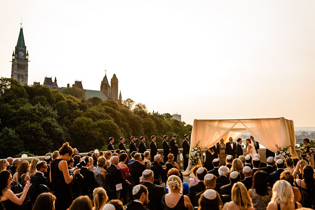Jewish wedding ceremony taking place on Ottawa's Chateau Laurier terrace overlooking the parliament buildings