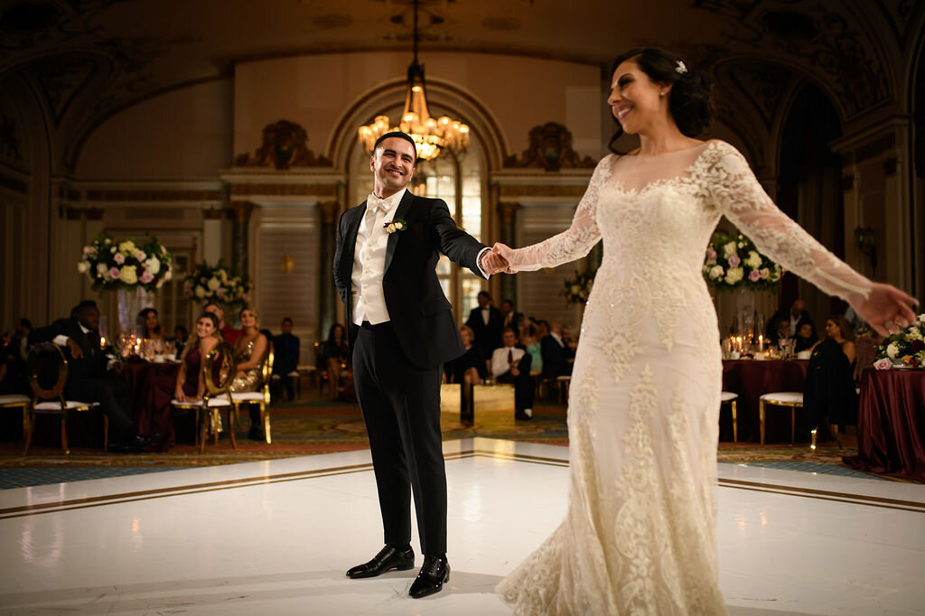 groom showing off his bride during first dance inside Ottawa Chateau Laurier