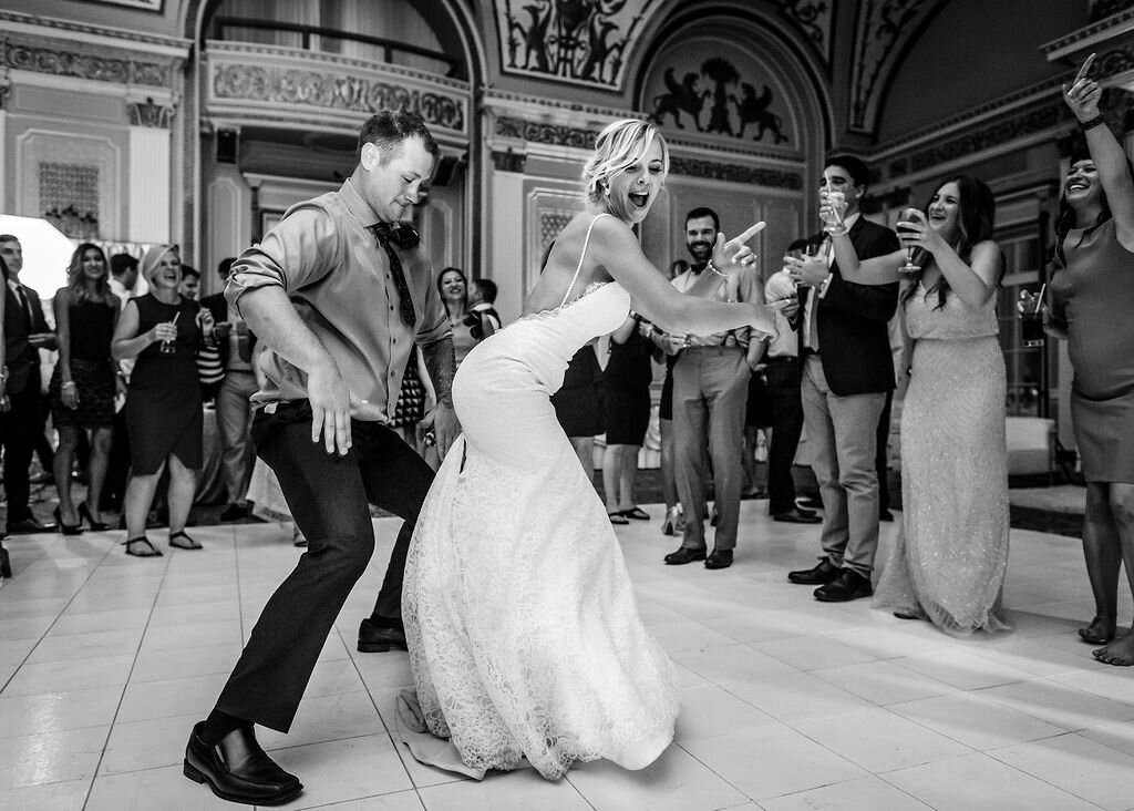 fun bride shaking her behind on dancefloor with wedding guest at Chateau Laurier in Ottawa