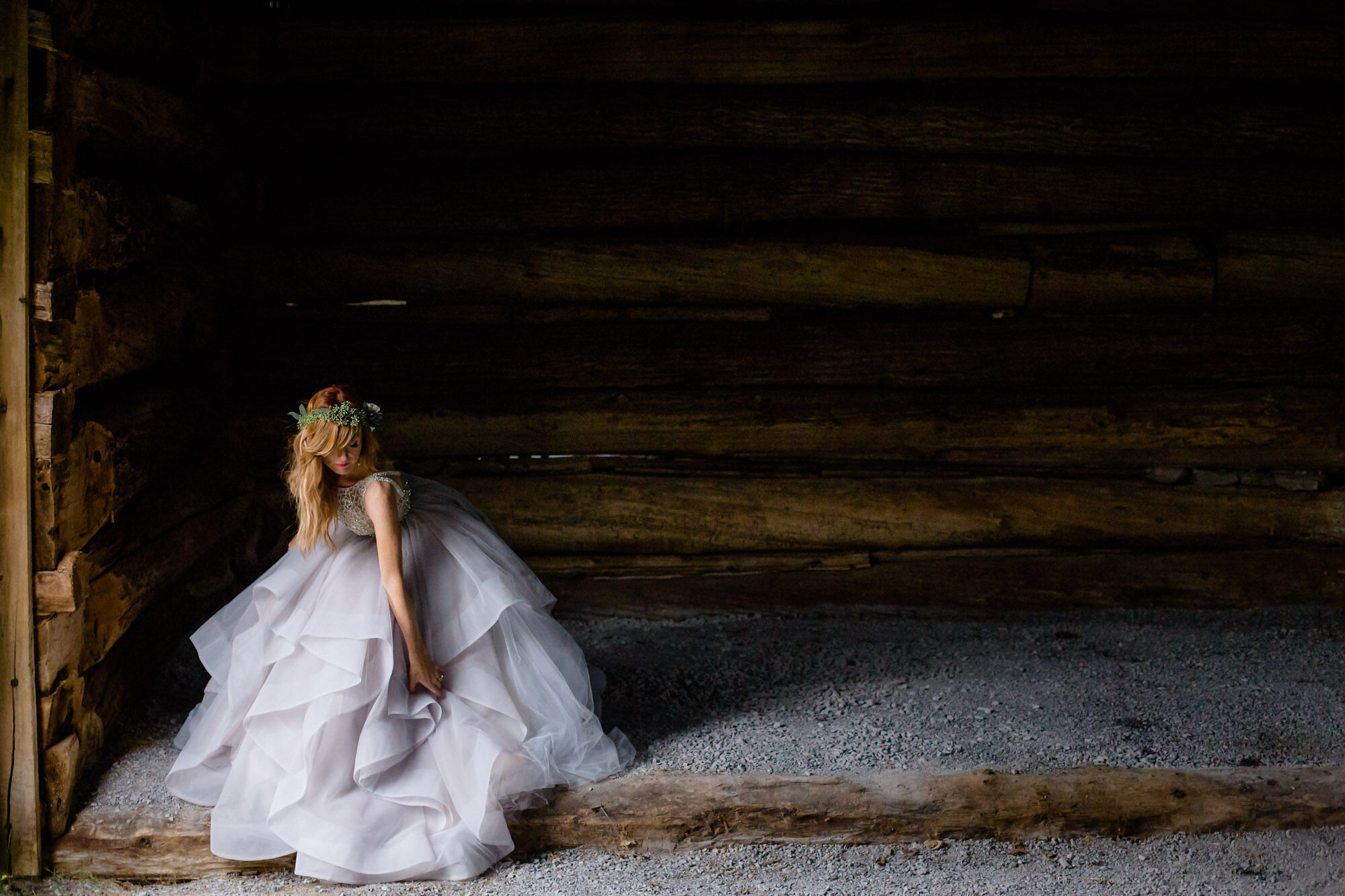 bride fluffing her gown in barn at Stonefields Estate in Beckwith, Ontario