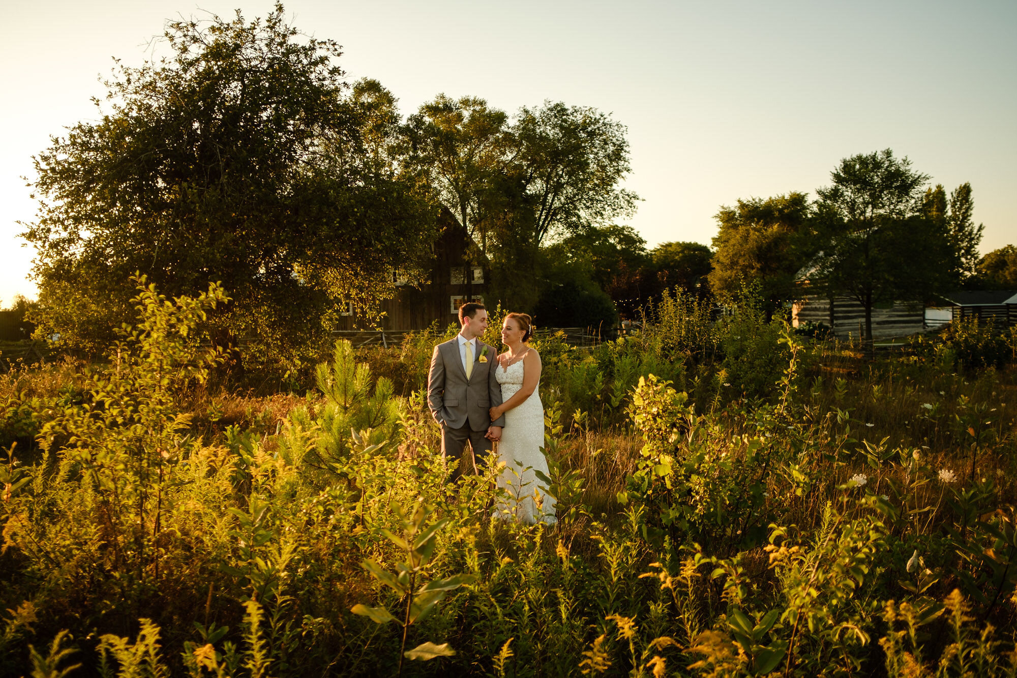 Bride and groom standing in a field after their wedding at Stonefields Estate